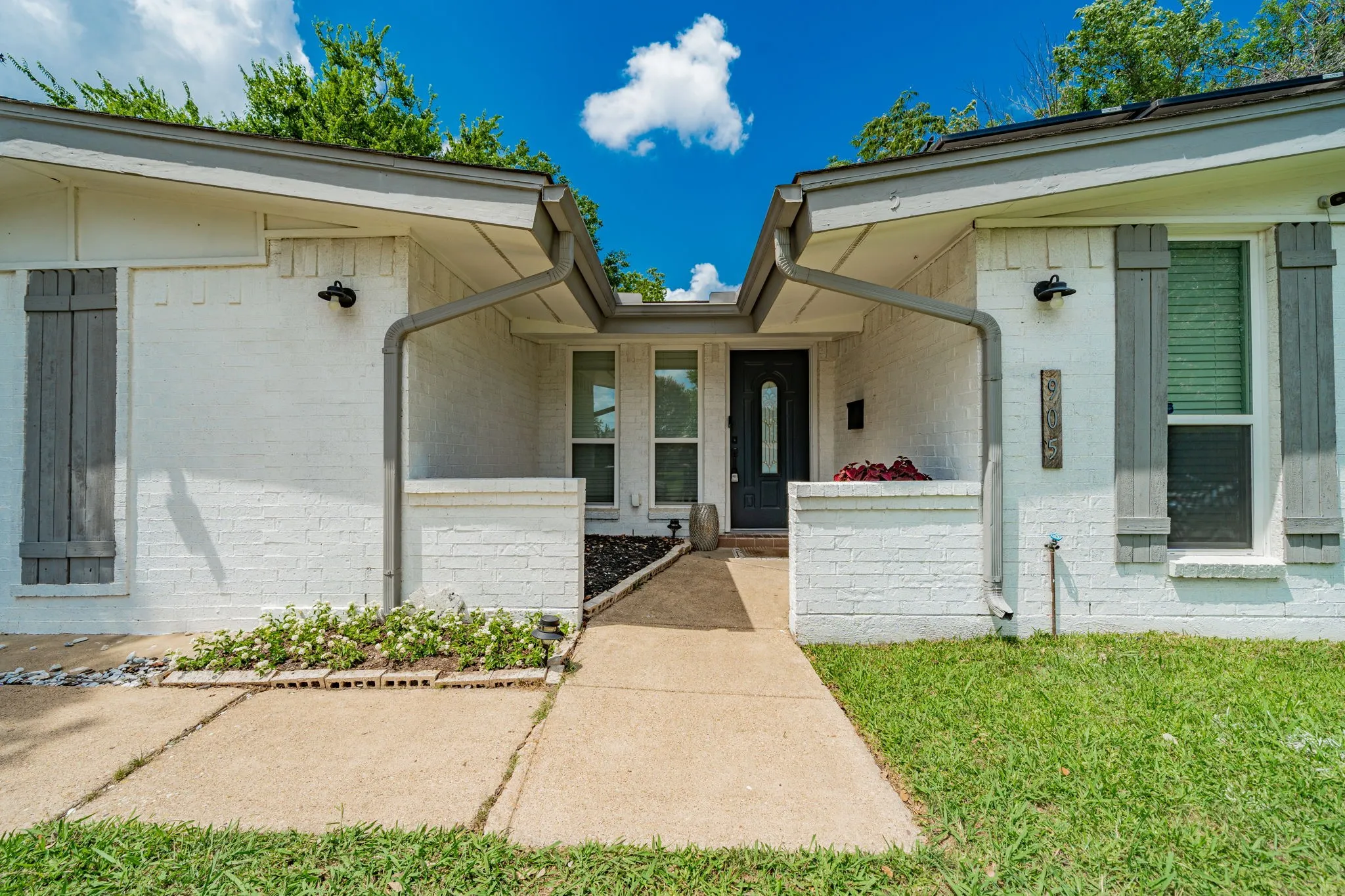 View of exterior entry with brick siding