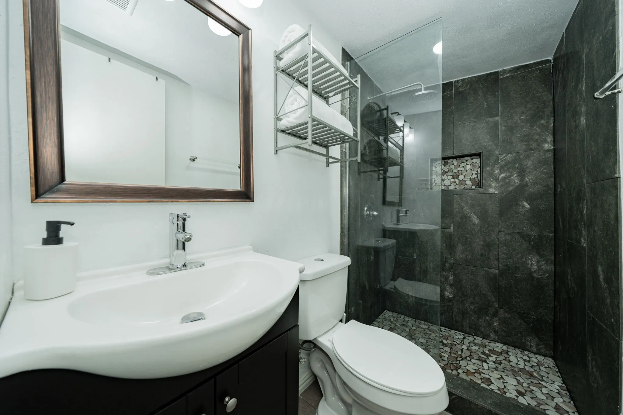 Full bath with vanity and tiled shower