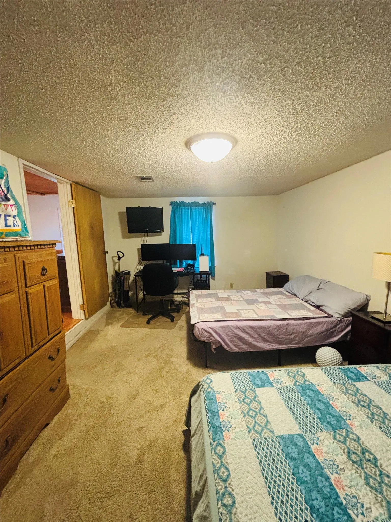 Recessed lighting, light-colored walls, and carpet flooring