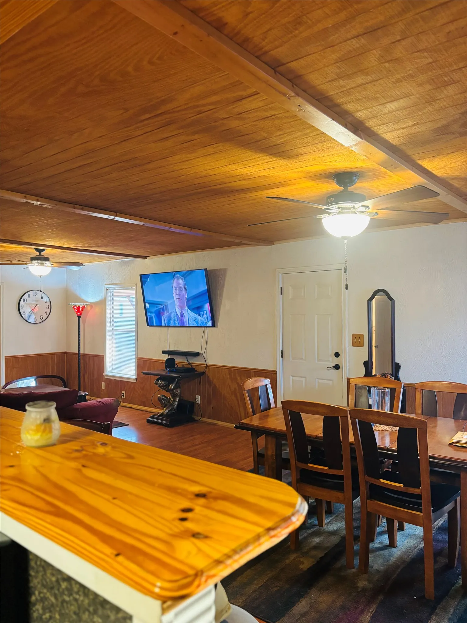 Wood-finish ceiling with exposed beams and ceiling fans