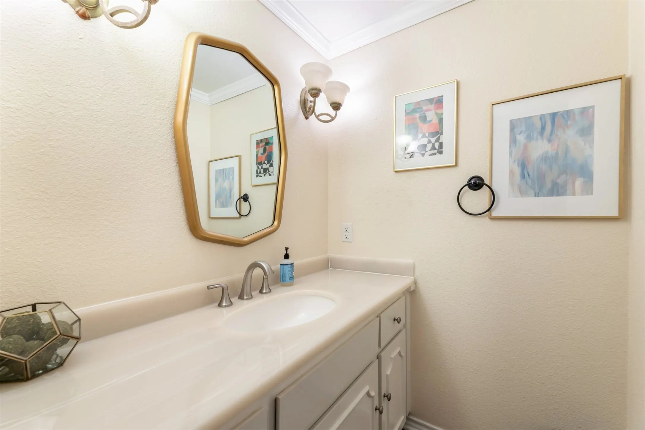 Single vanity with an integrated sink, brushed nickel faucet, and a light-colored countertop