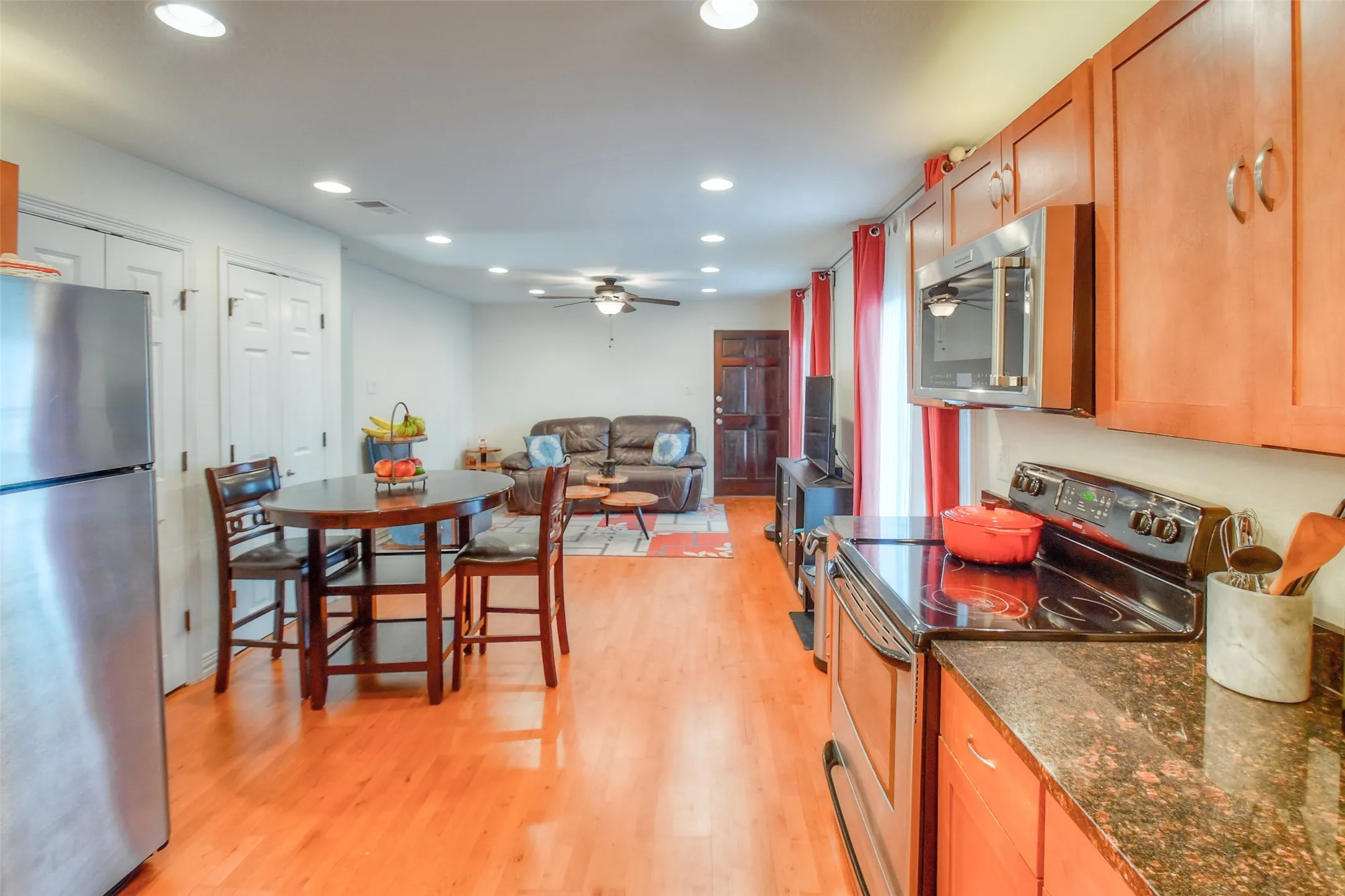 Kitchen with visible vents, a ceiling fan, appliances with stainless steel finishes, light wood-type flooring, and recessed lighting