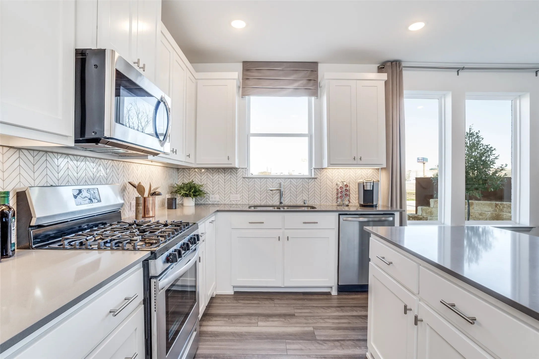 Beautiful cabinetry, gorgeous counter tops and designer backsplash effortlessly pair with contemporary stainless steel to create a kitchen for the ages!