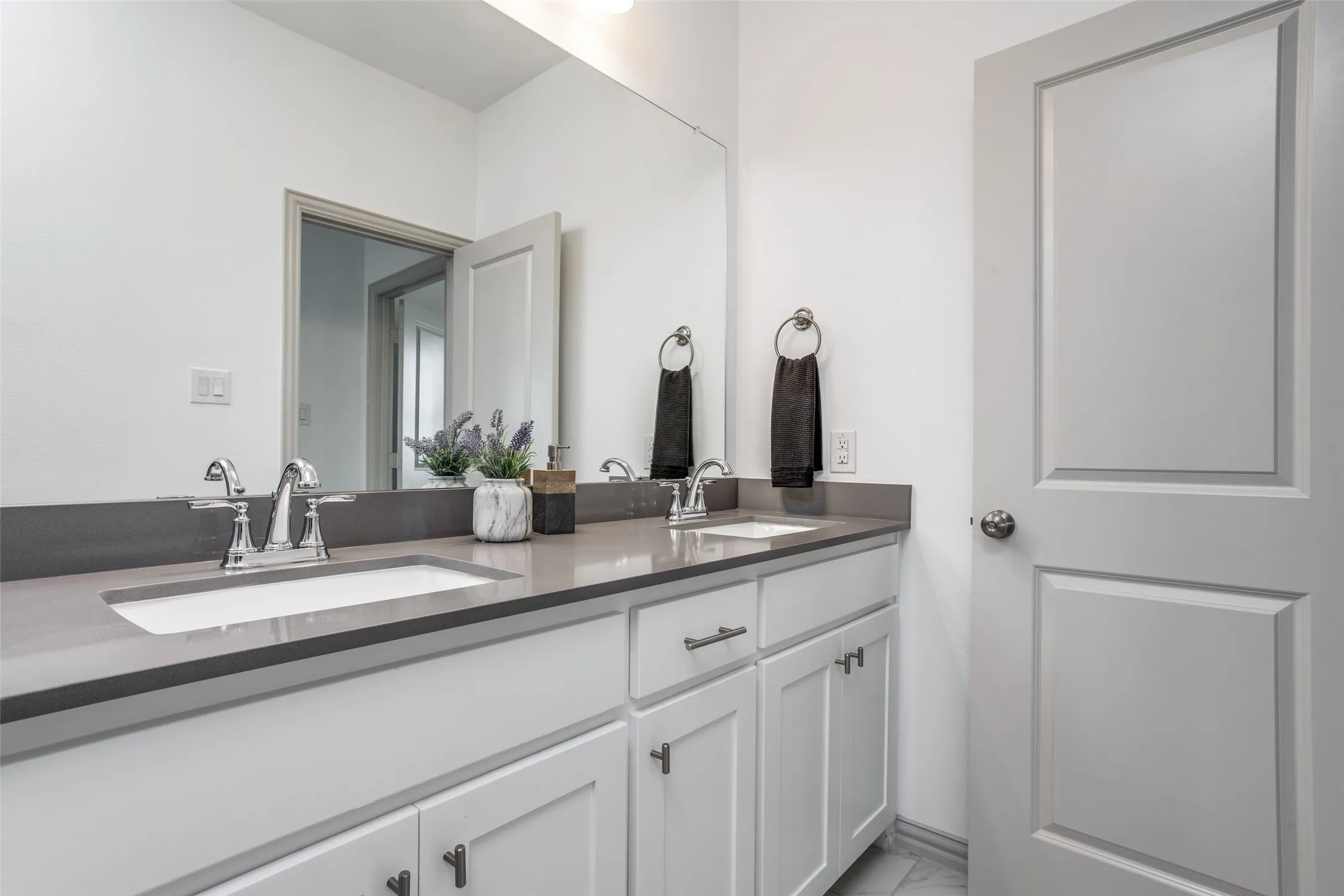 Friends and family will enjoy their won vanity space in this thoughtfully designed guest bath.
