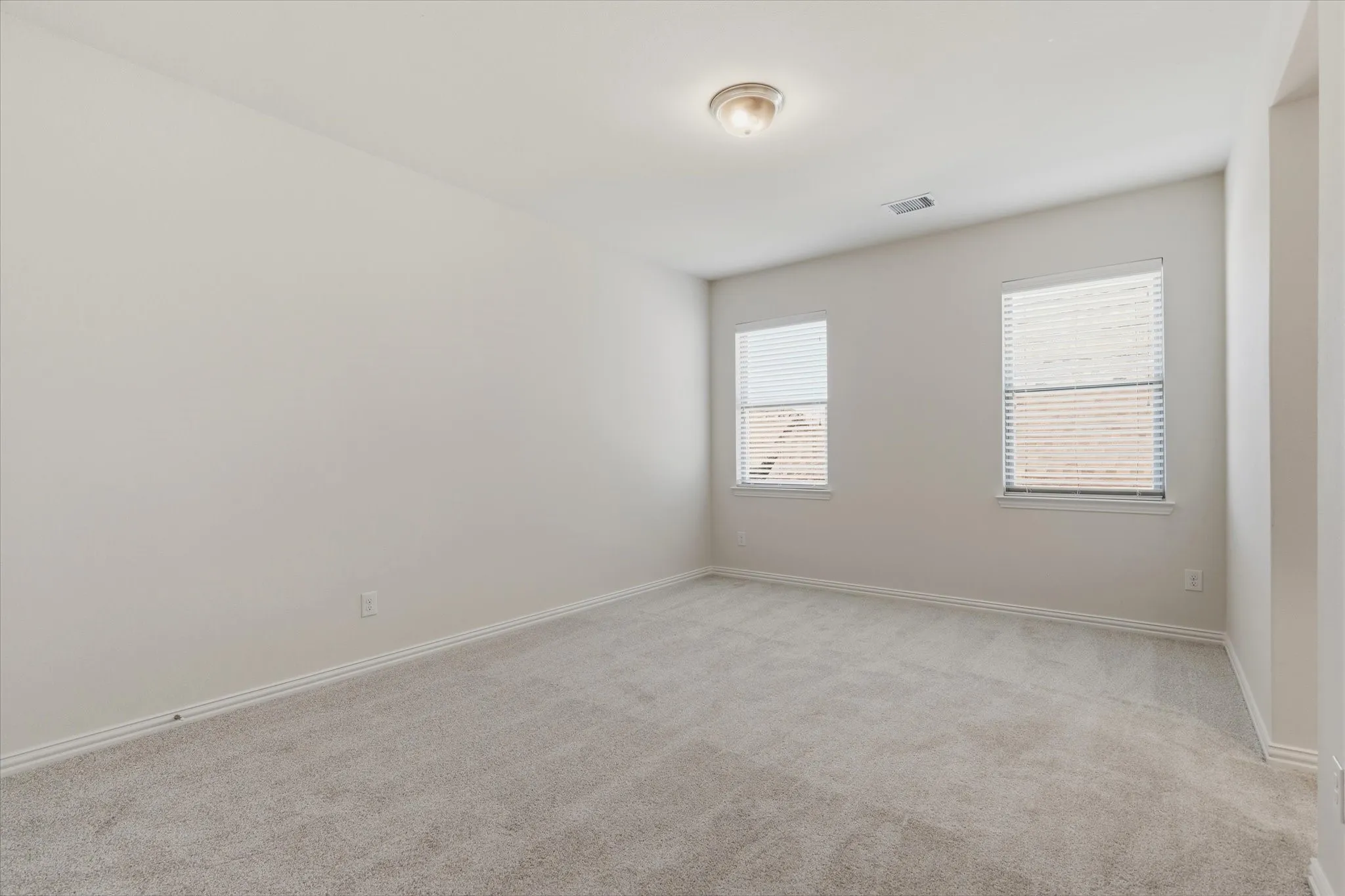 Neutral-toned walls complement the light-colored carpeting