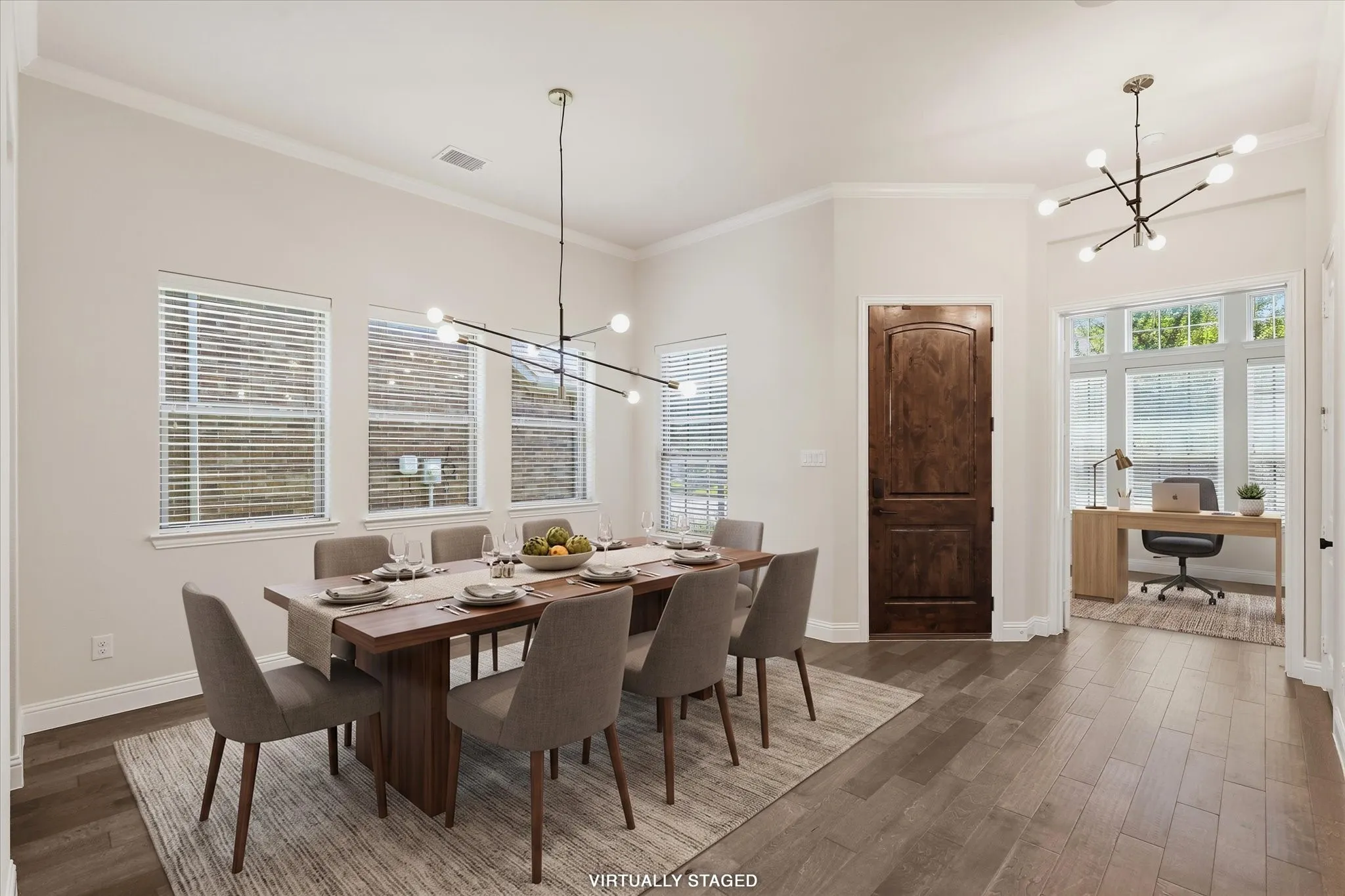 Formal Dining room with wood flooring, updated chandeliers and open to the designated home office. Virtually staged