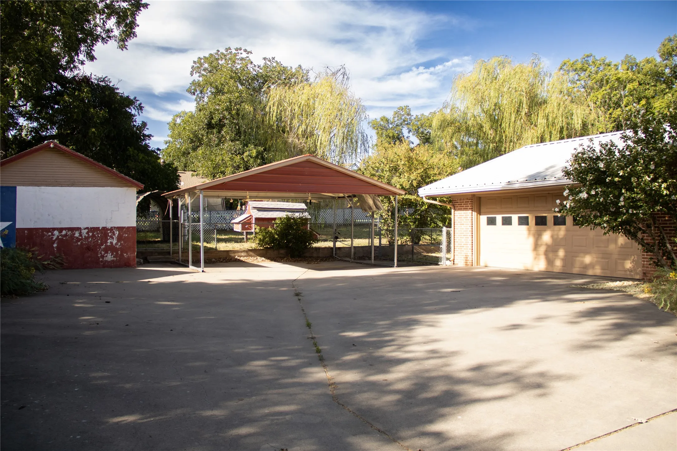 Driveway with carport, garaage and shop building