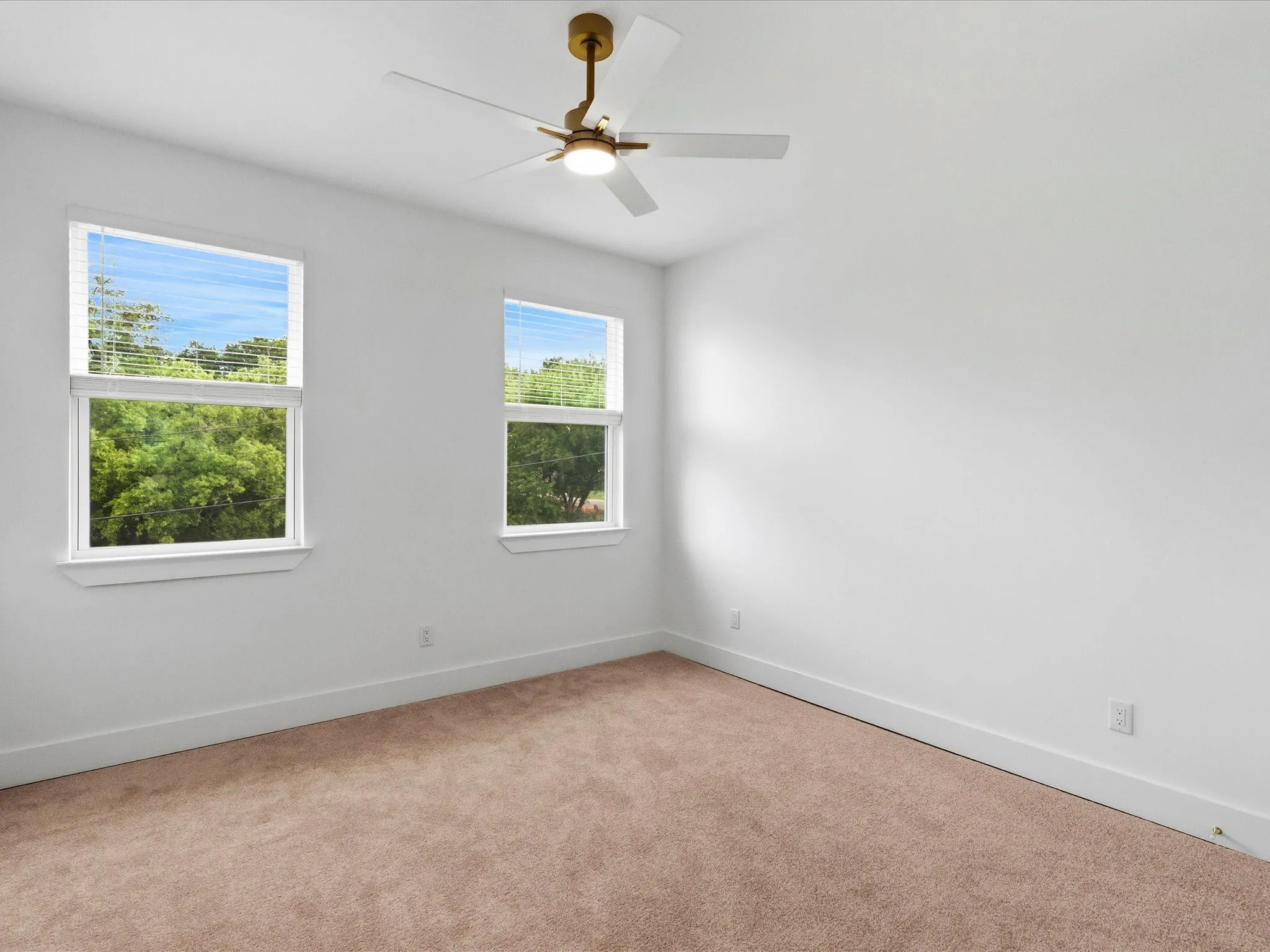 Recessed lighting, ceiling fan with light fixture, two windows, carpeted flooring, and white painted walls