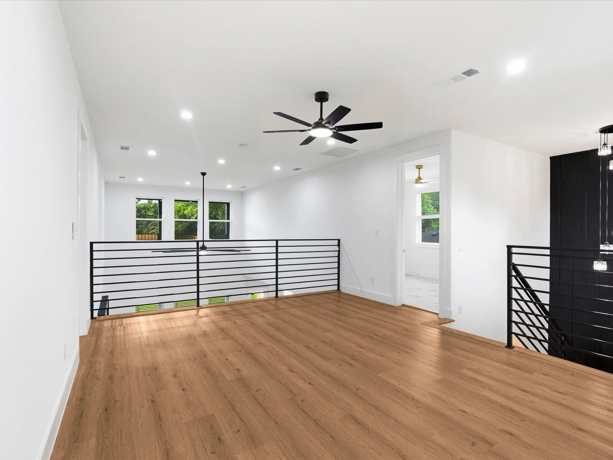 Open-concept loft with wood-finish flooring