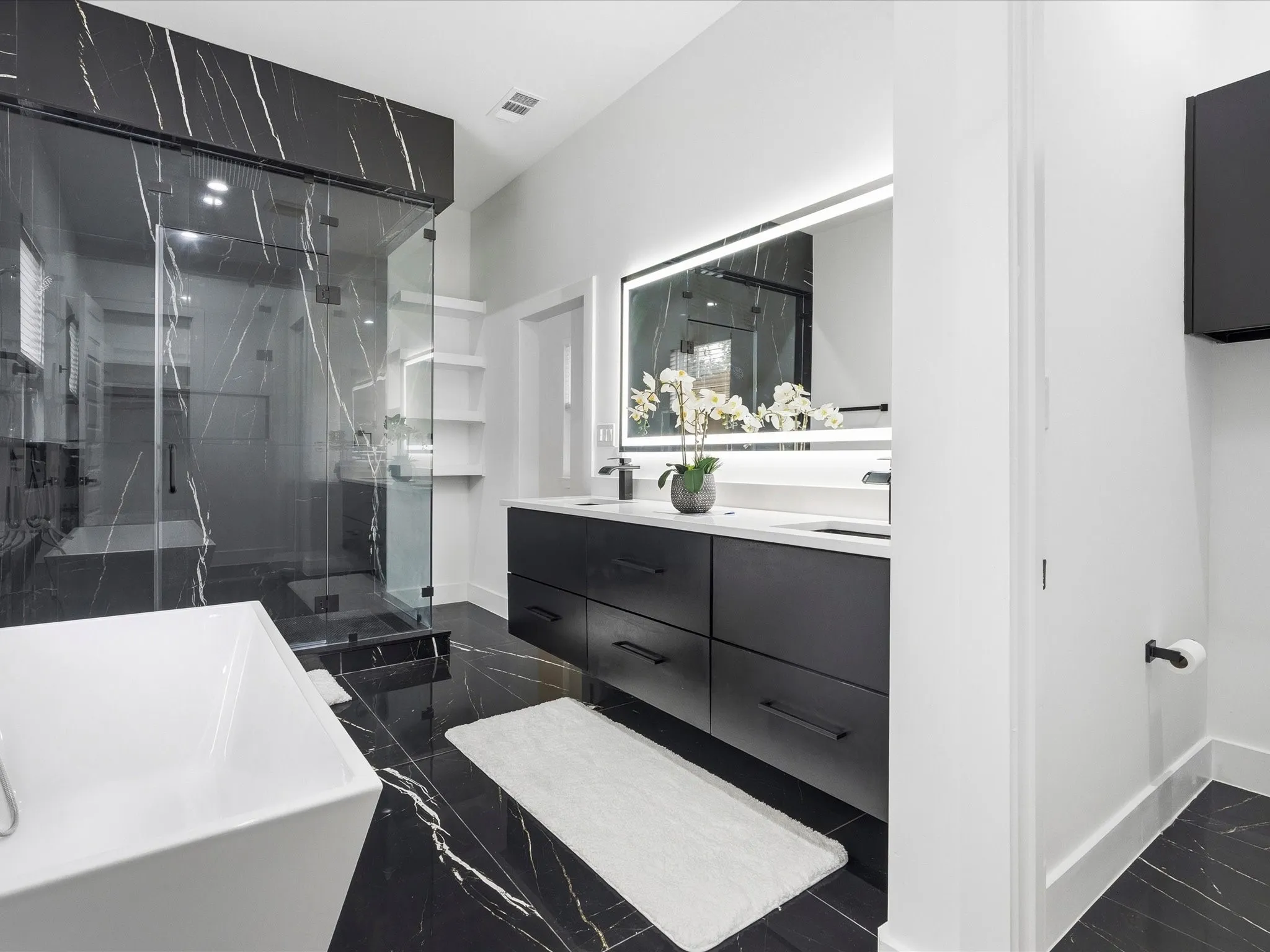 Contemporary bathroom featuring a freestanding tub and a spacious glass-enclosed shower