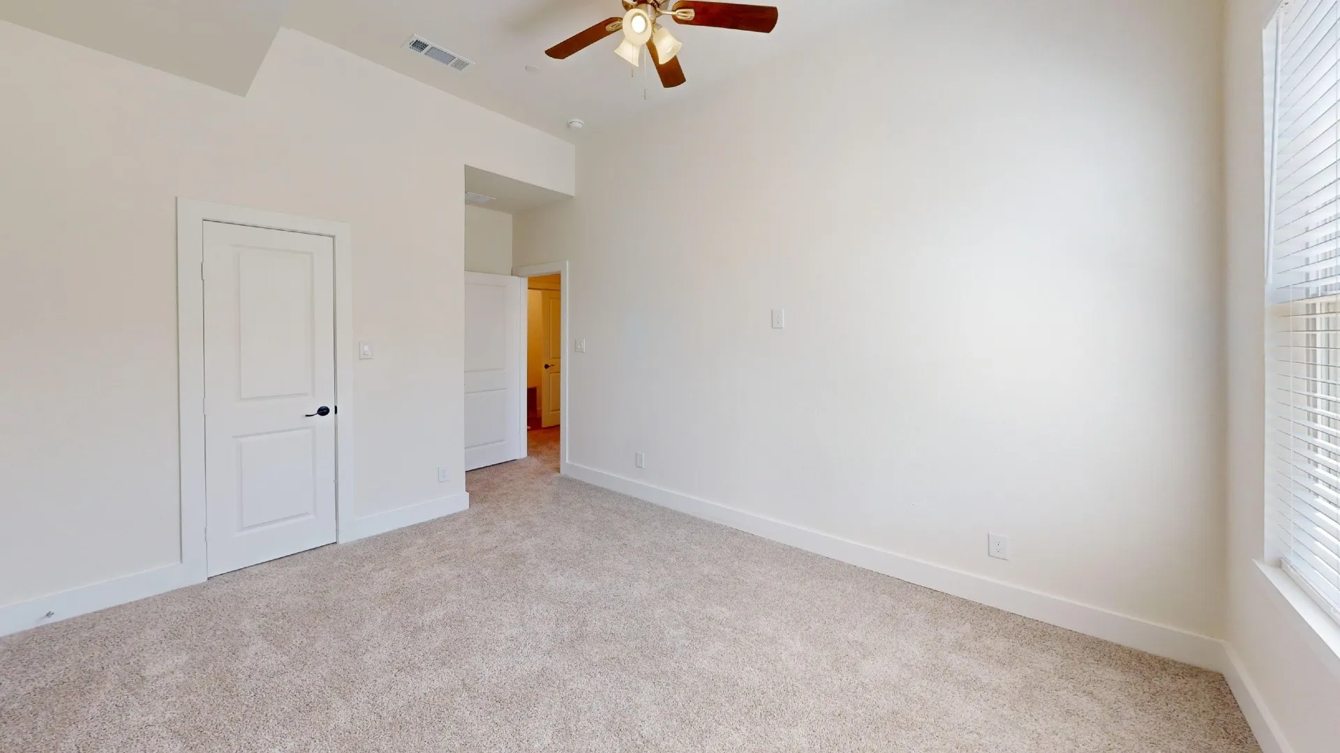 Wall-to-wall carpeting, high ceilings, ceiling fan with light fixture, and window with horizontal blinds