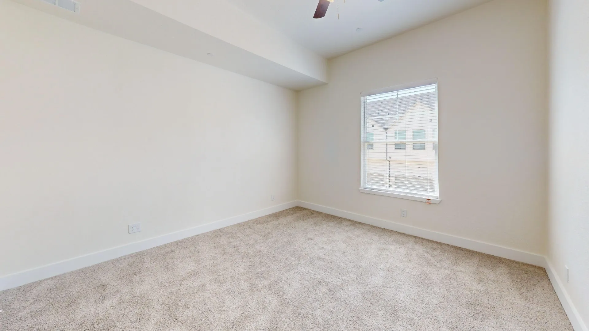 Neutral-toned carpeting throughout the room