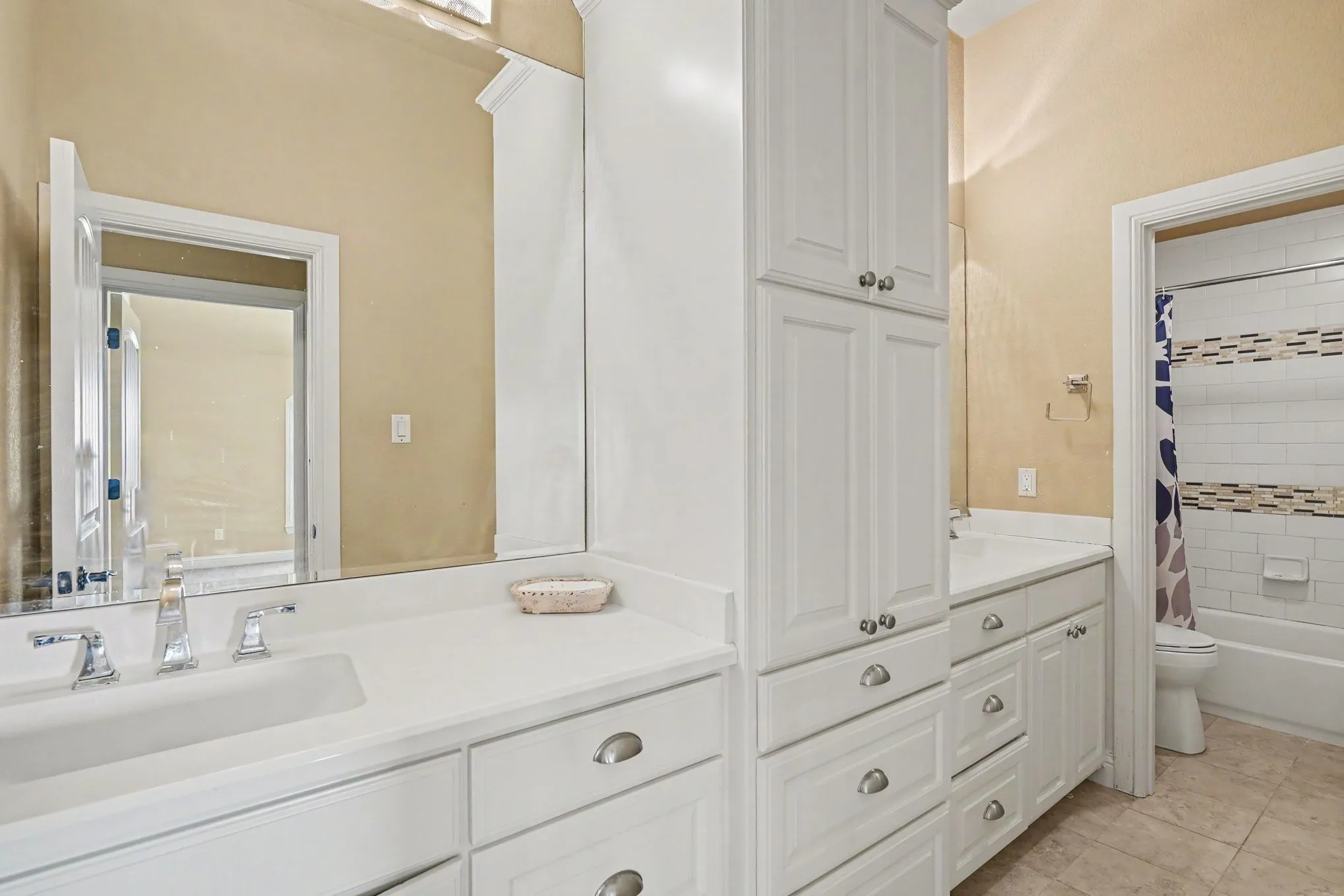 Dual vanity with integrated sinks and chrome fixtures. Upstairs bathroom