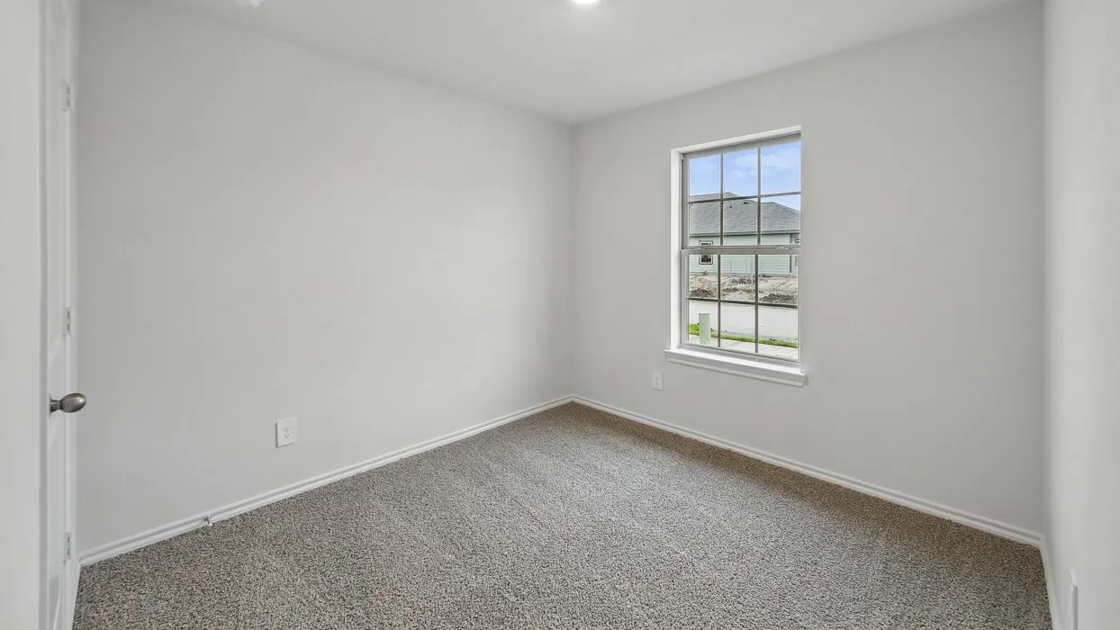 Light-colored wall-to-wall carpeting, white painted walls, and a multi-pane window