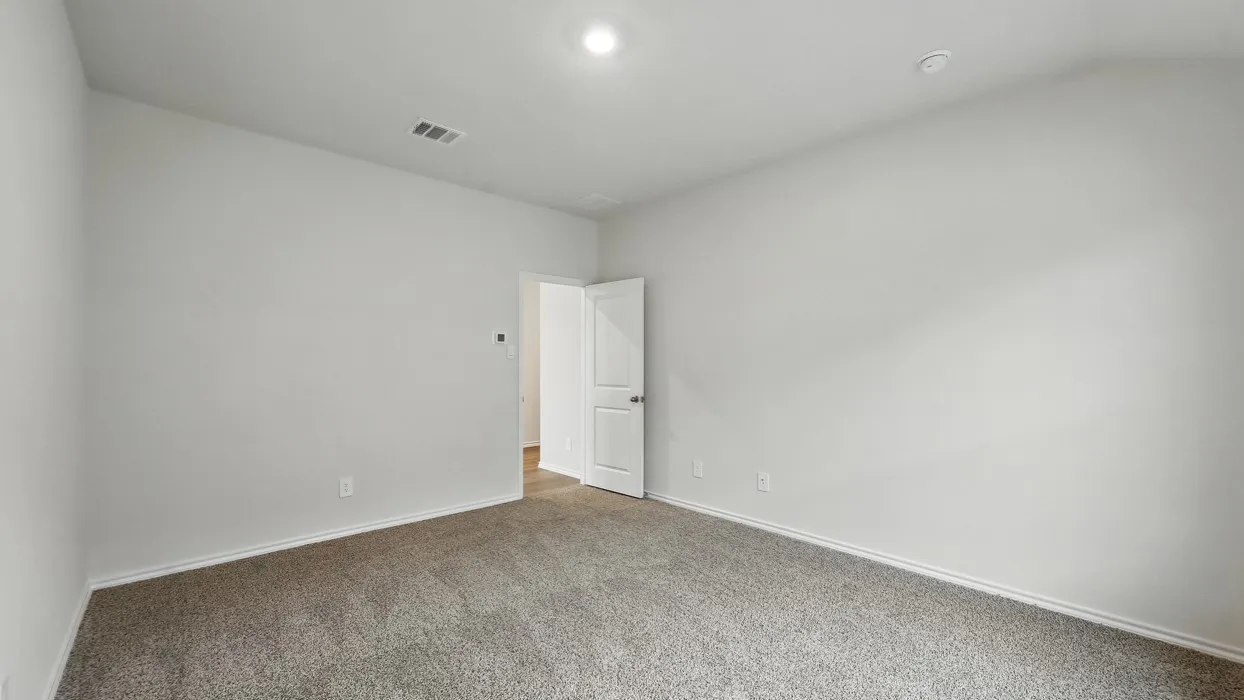 Neutral tone wall paint with carpeted flooring and an overhead light fixture