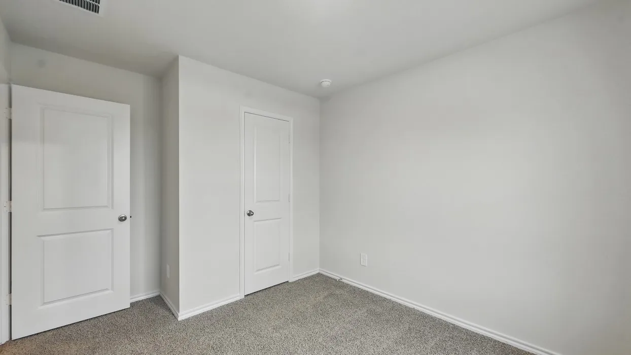 Carpeted flooring, white interior doors, and neutral wall finishes