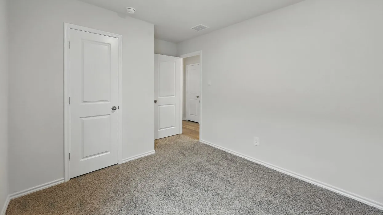 Neutral wall color, carpet flooring, two-panel interior doors, and recessed lighting