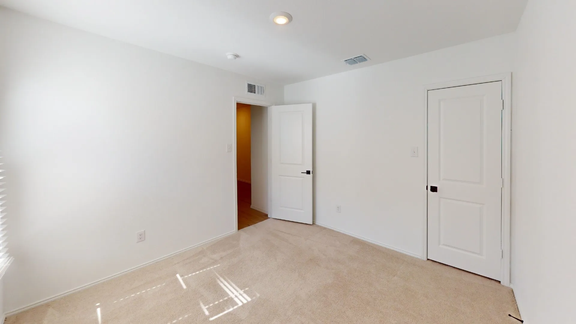 Neutral color palette with light beige carpeting and white walls