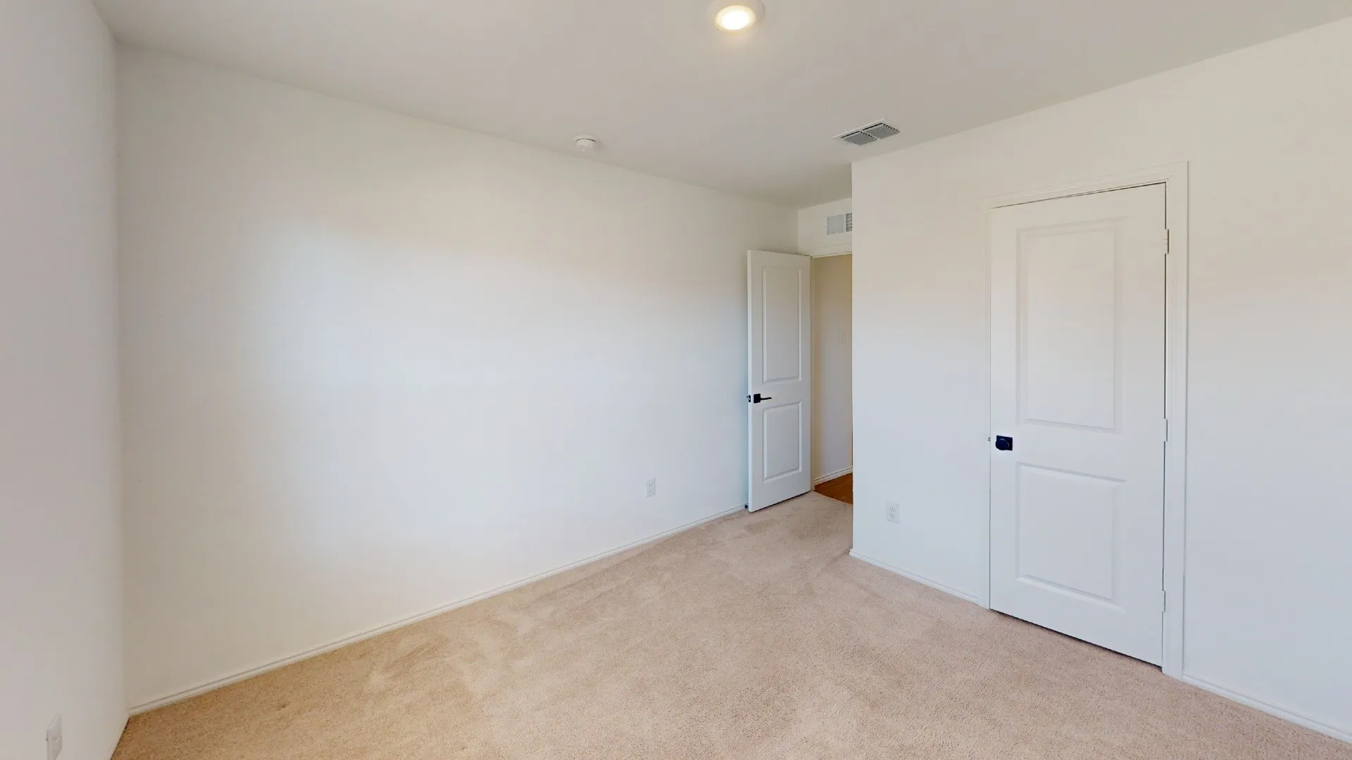 Neutral-toned carpeting, white walls, and recessed lighting