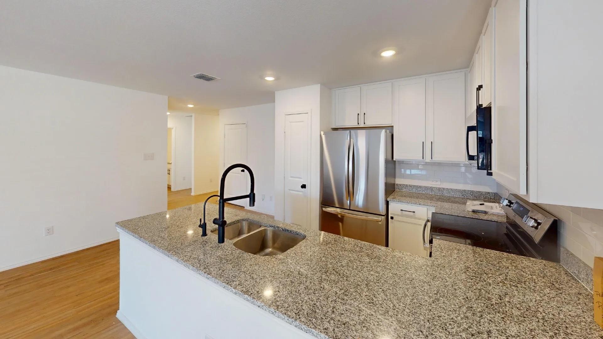Kitchen island with granite countertops and an undermount sink