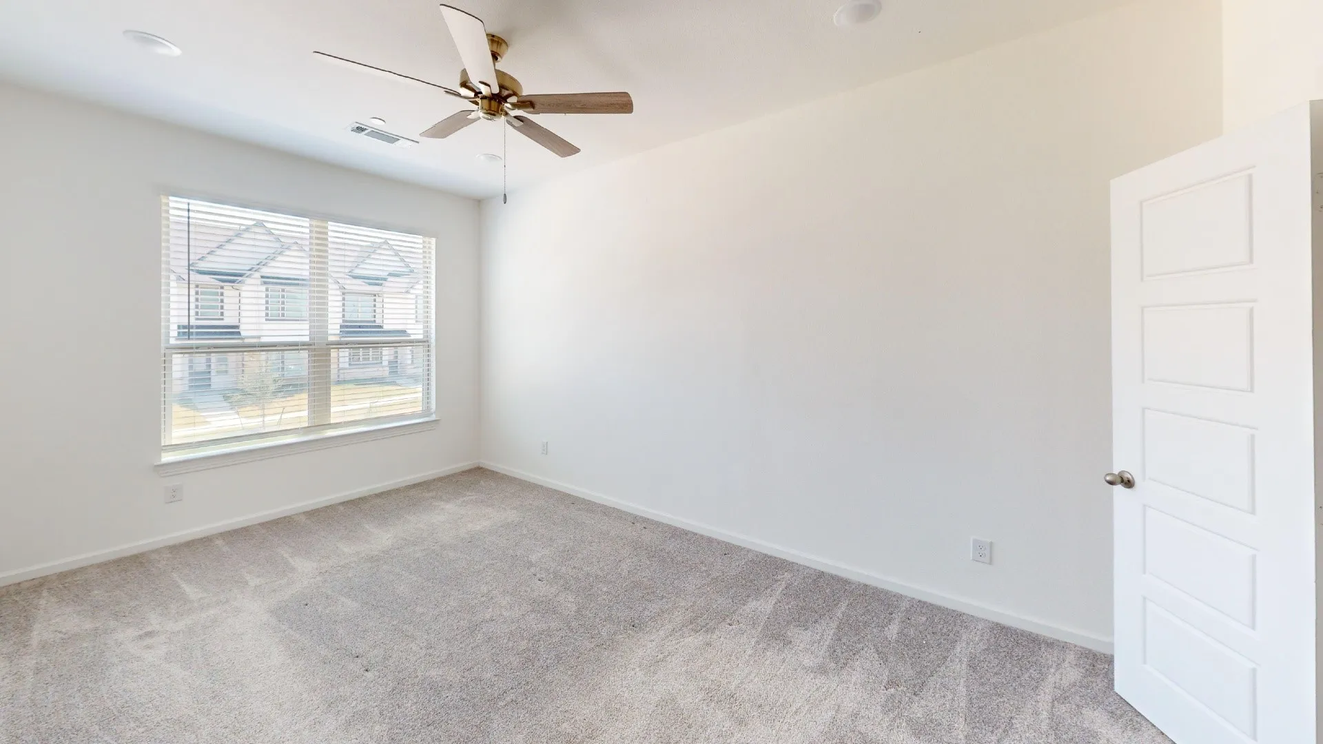 Bright room with carpeted flooring, a large window, a ceiling fan, and recessed lighting