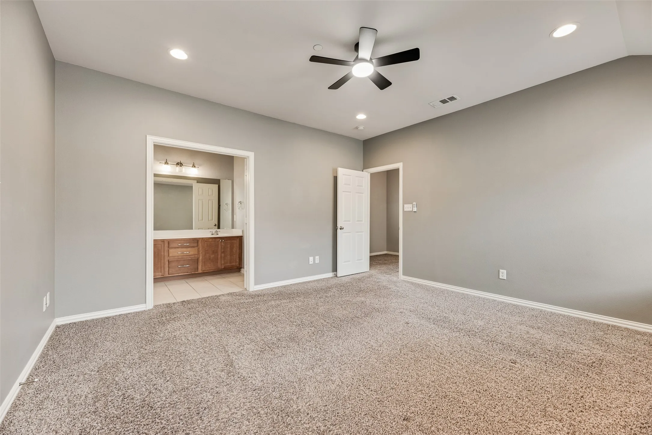 Recessed lighting, ceiling fan, and carpeted flooring
