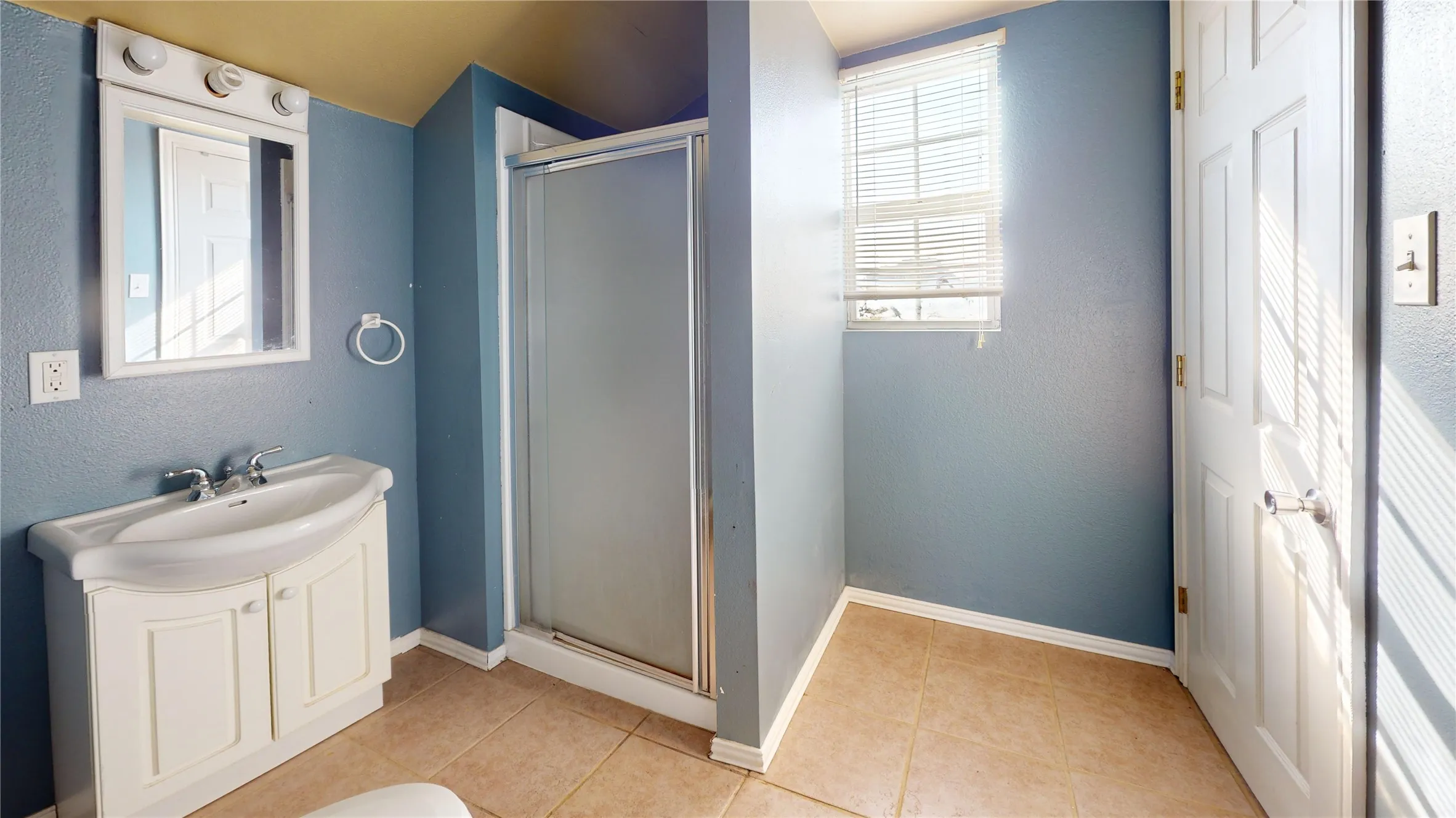 Vanity with integrated sink, chrome faucet, and storage cabinetry