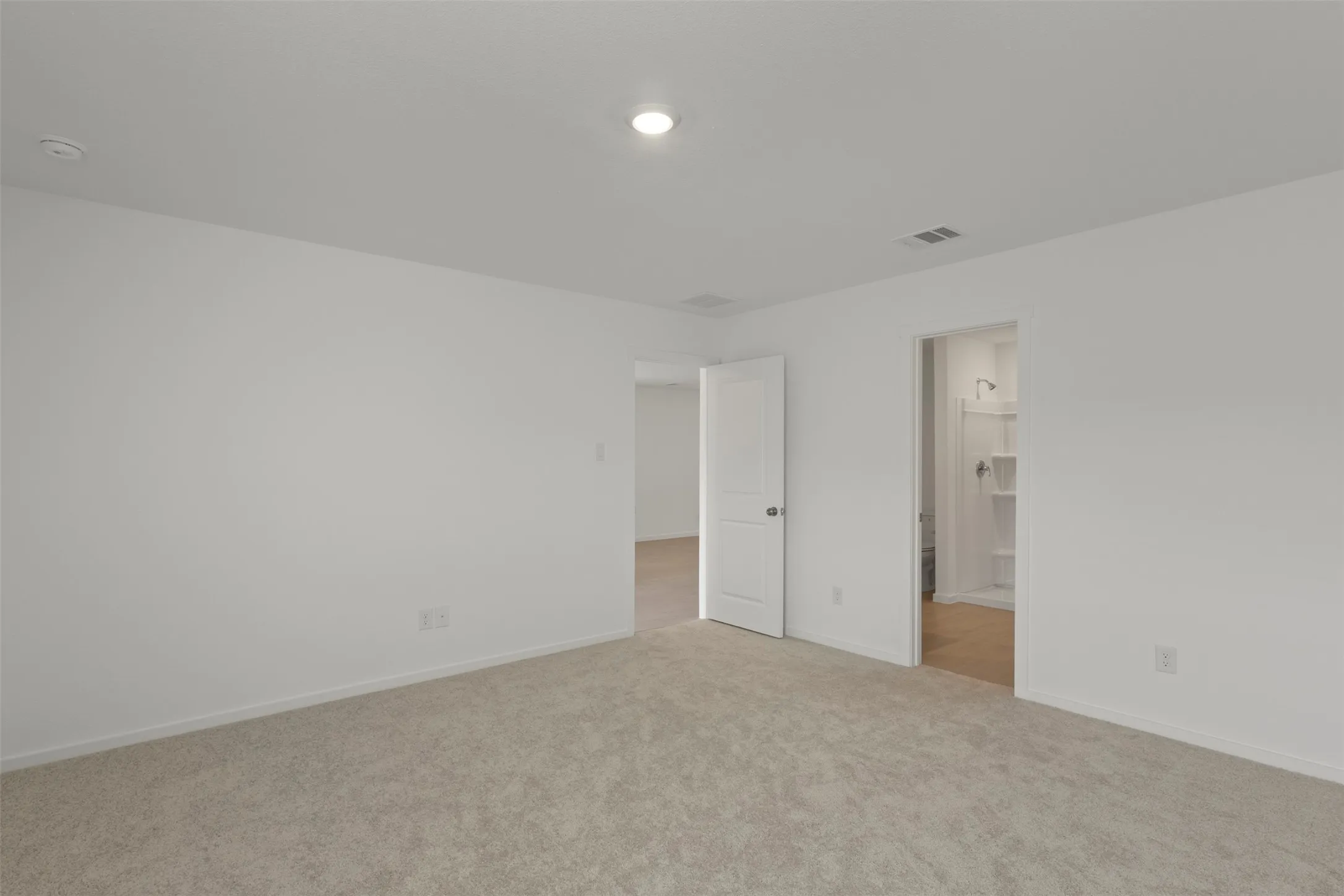 Neutral tone wall paint, recessed lighting, and carpeted flooring