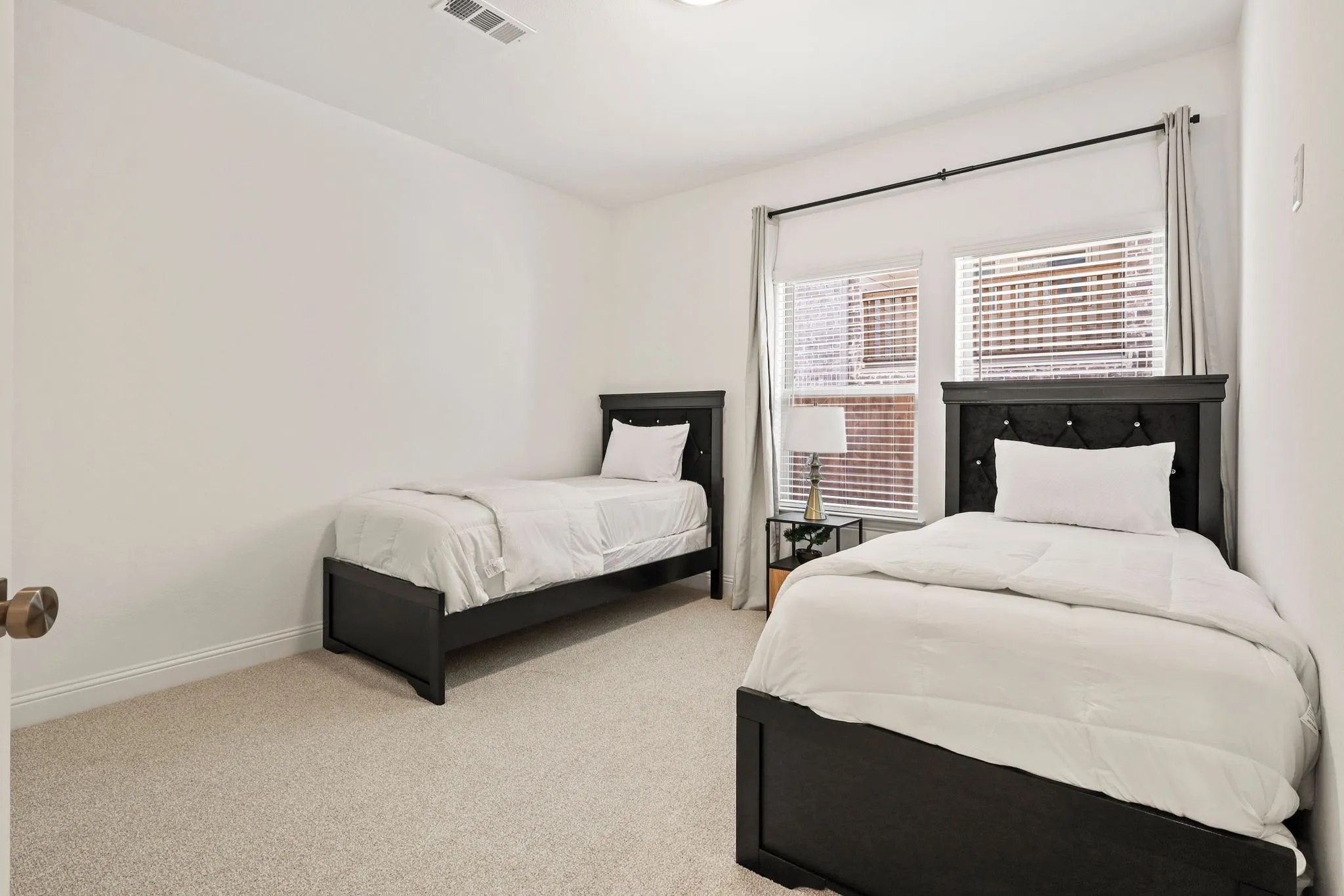 Bedroom featuring light carpet