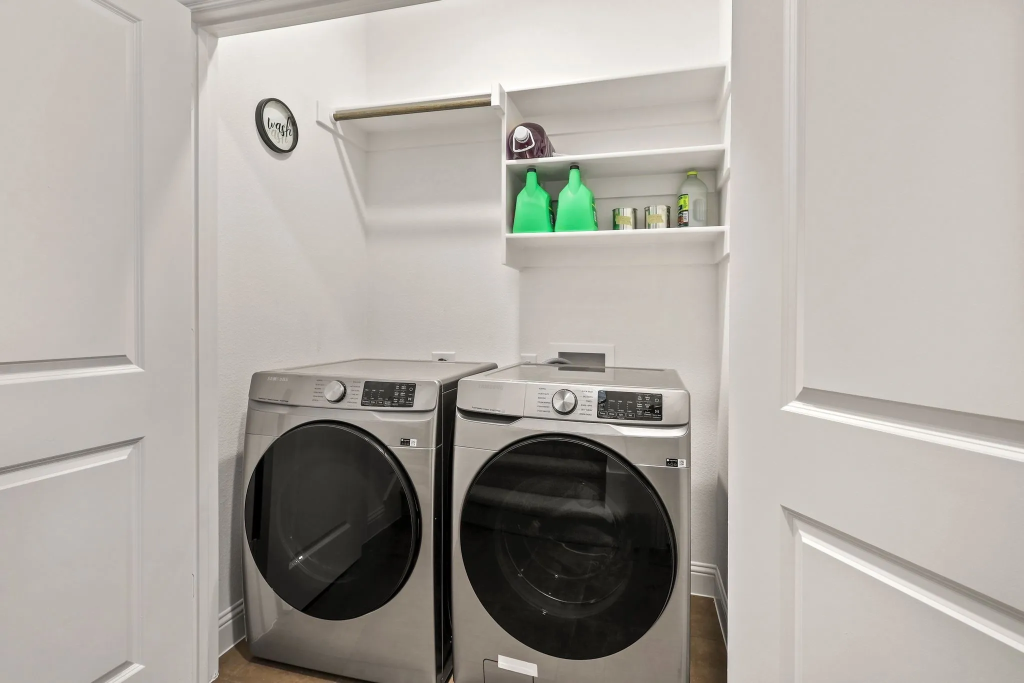 Clothes washing area featuring washer and clothes dryer