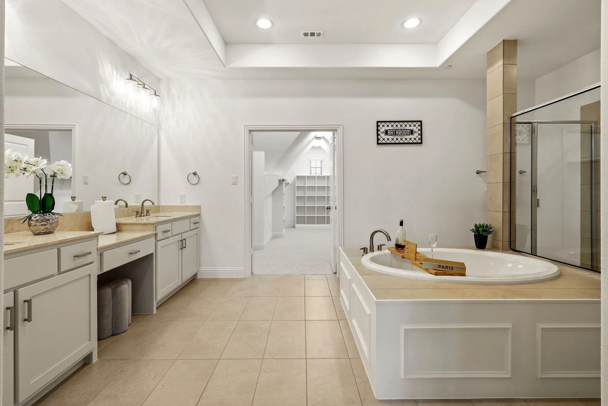 Bathroom with independent shower and bath, tile patterned flooring, a raised ceiling, and vanity
