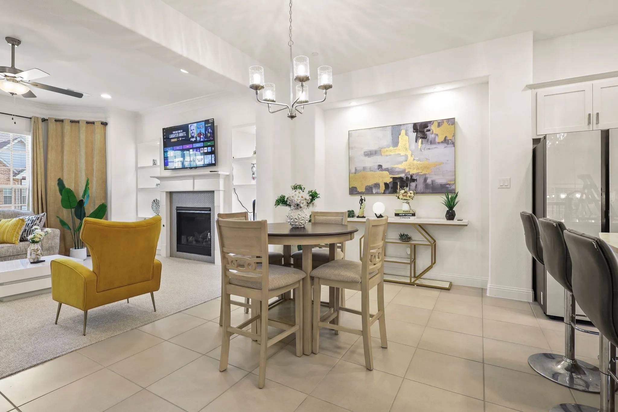Tiled dining area with ceiling fan with notable chandelier and ornamental molding