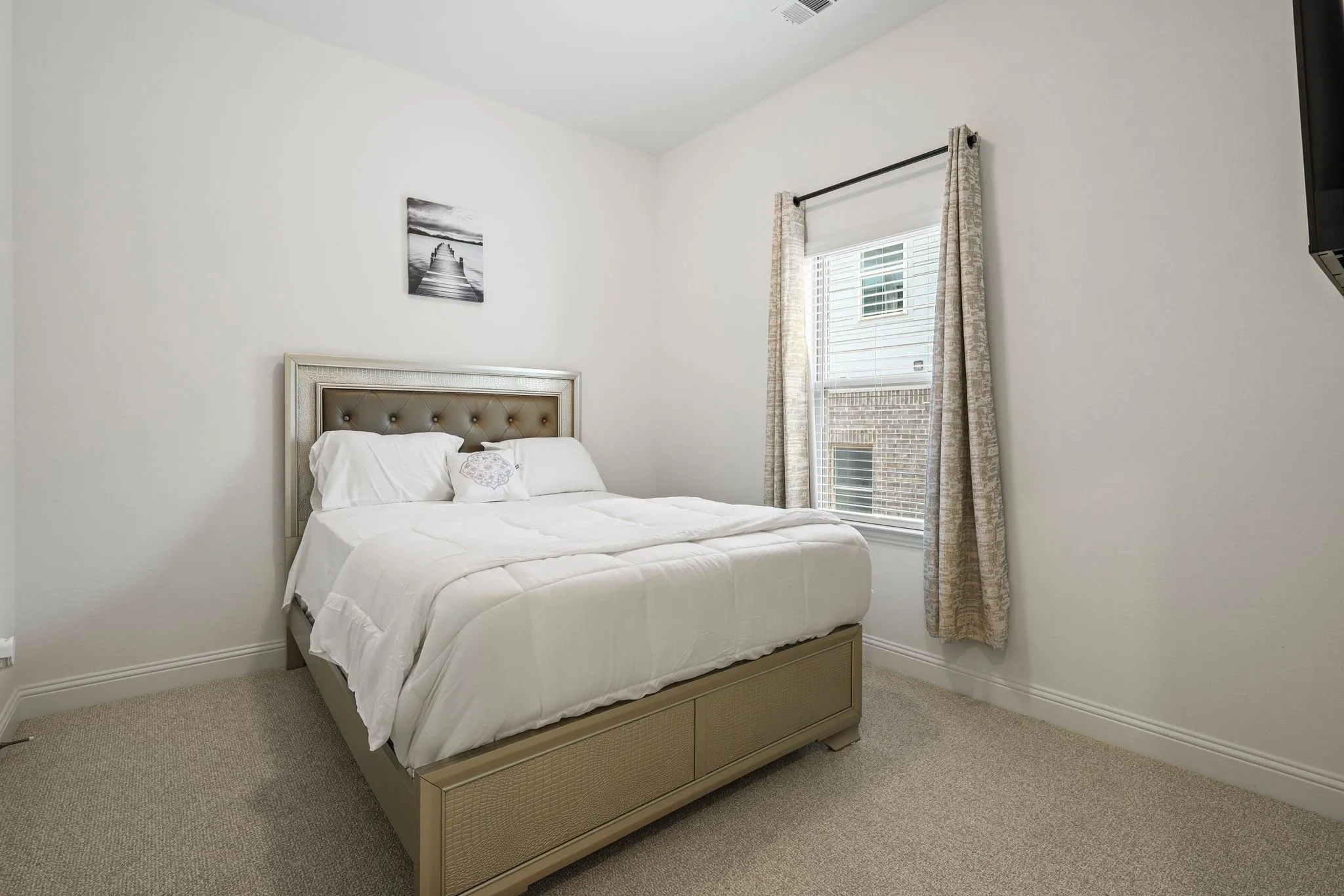 Bedroom with light colored carpet