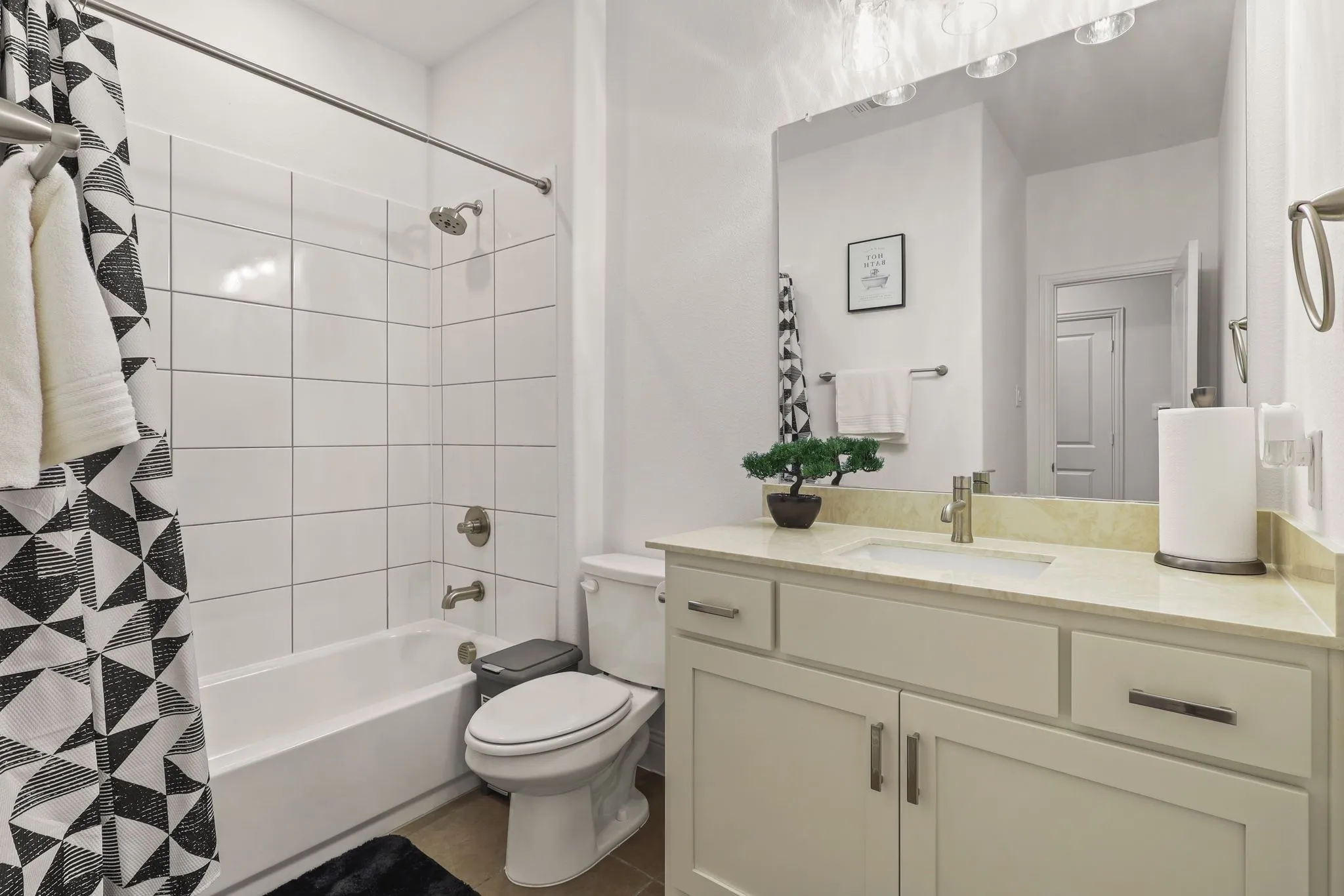 Full bathroom featuring toilet, shower / bath combo, and vanity