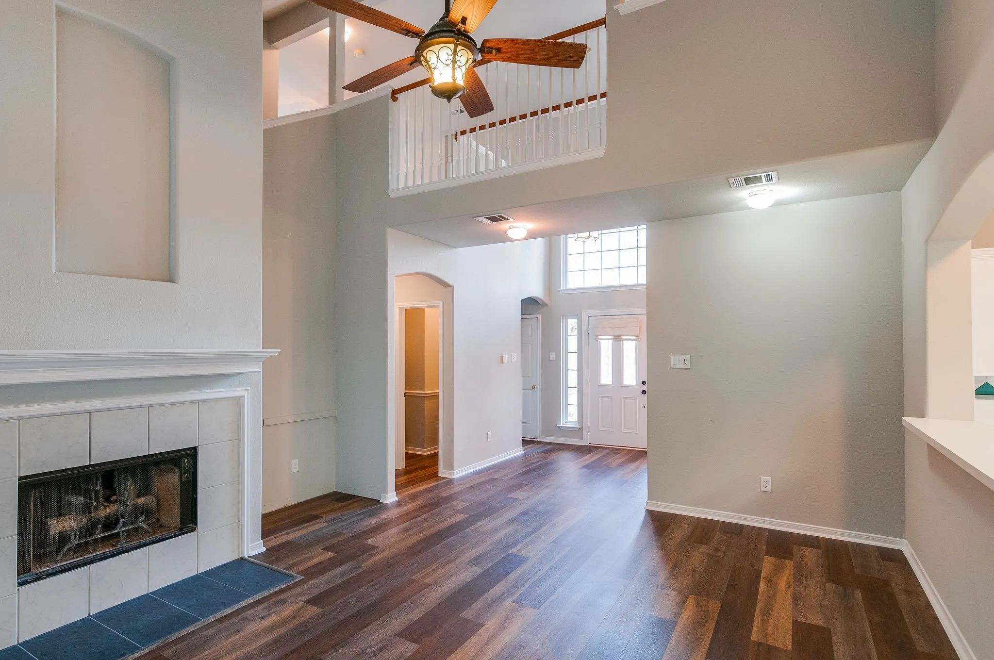 Vaulted ceilings, wood-finish flooring, and a tiled fireplace