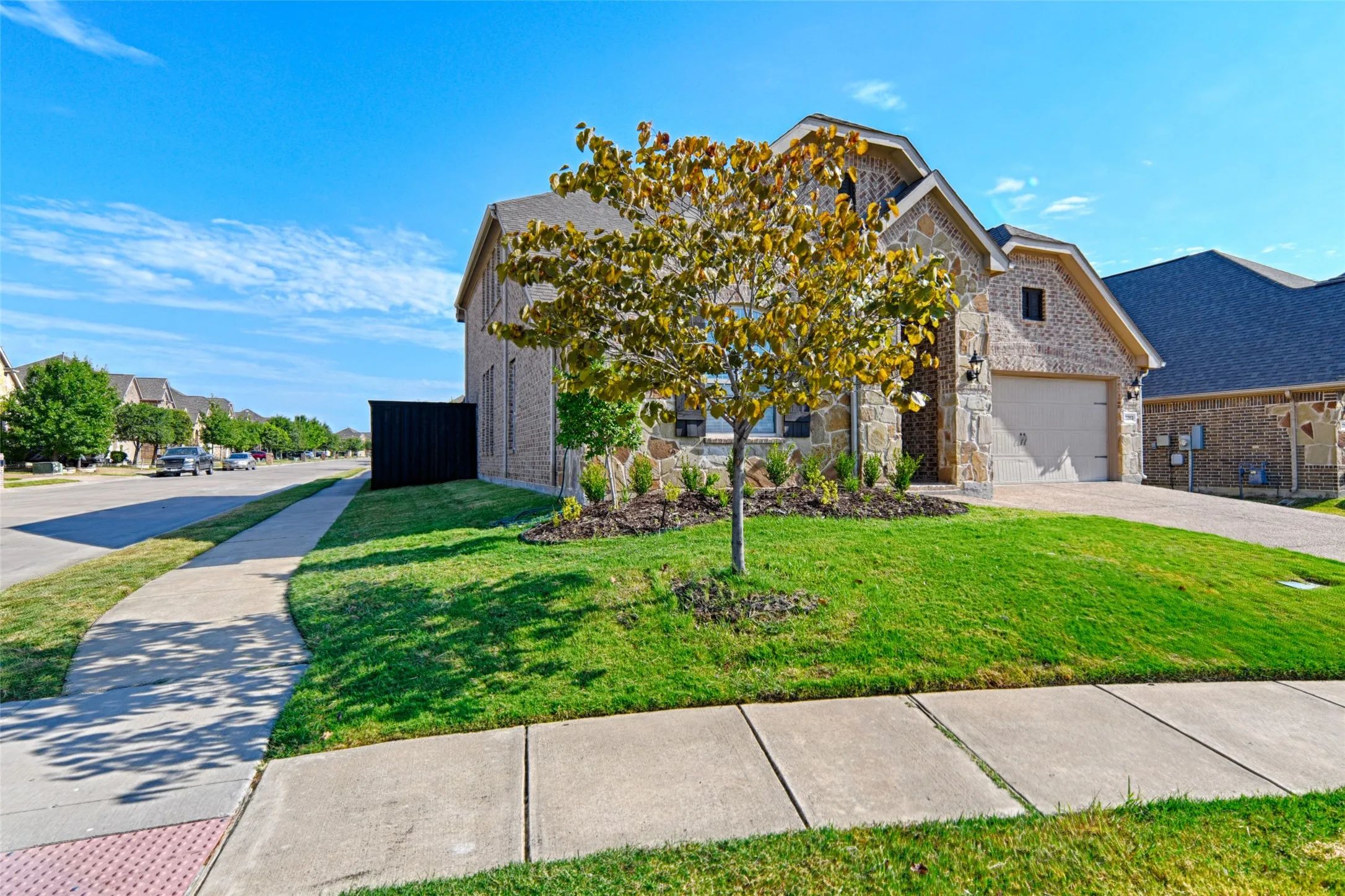 Stone and brick exterior with a two-car garage
