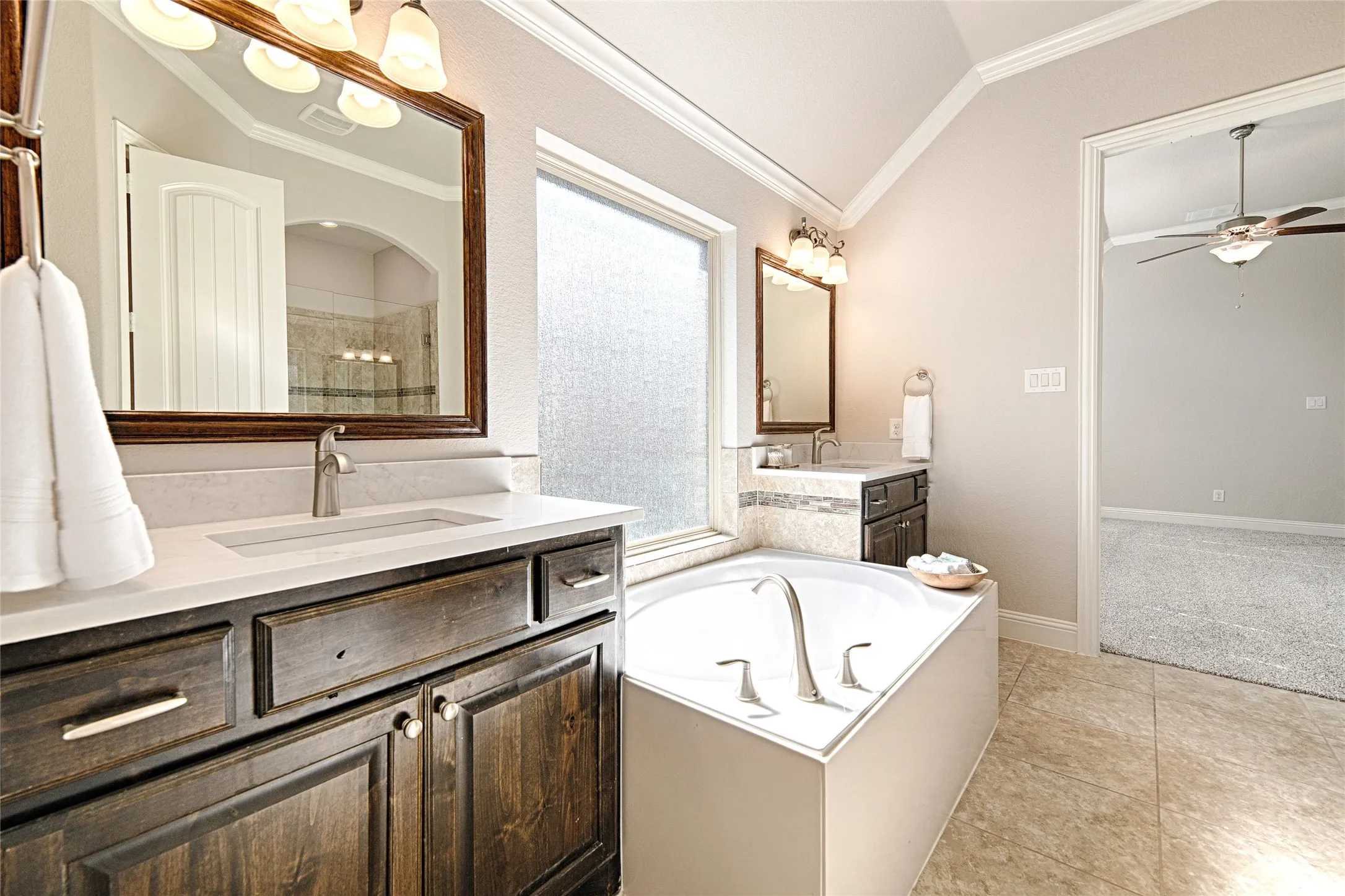 Dual vanity with dark wood-finish cabinetry and light-toned countertops