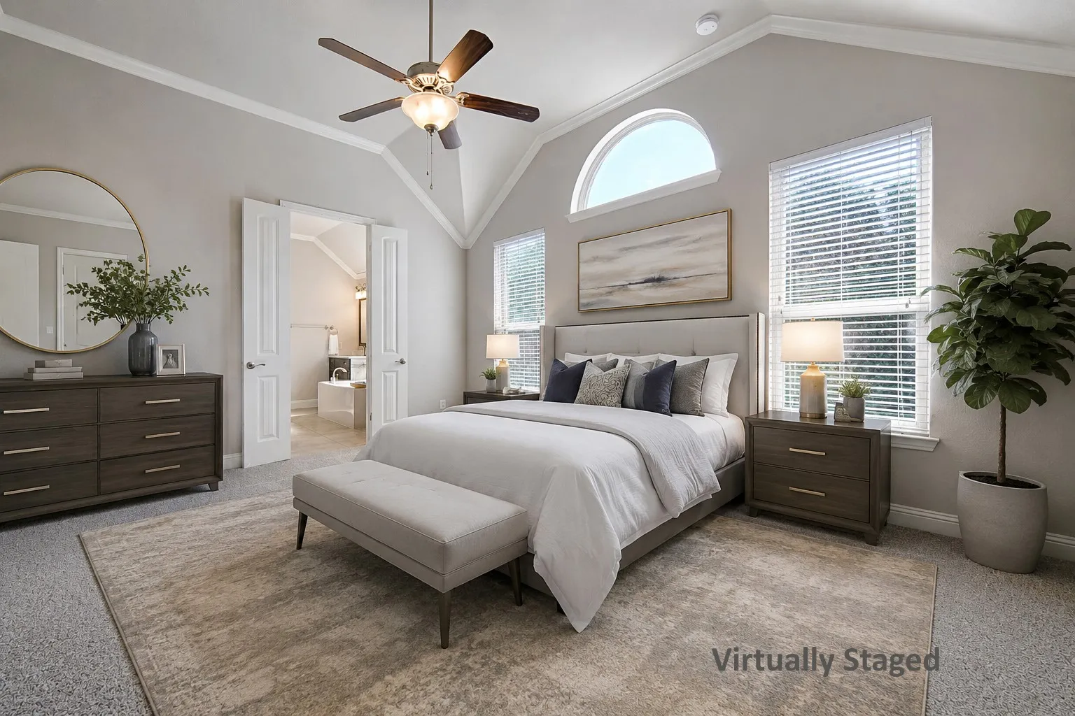 Primary bedroom. virtually staged. Vaulted ceiling with crown molding, ceiling fan with integrated lighting, arched transom window, dual windows with blinds, and double panel doors