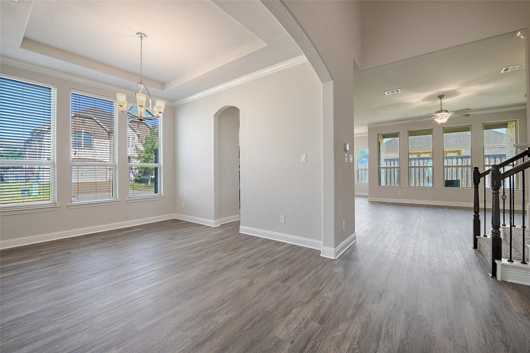 Formal Dining room open to entry with west facing windows and arched opening to kitchen