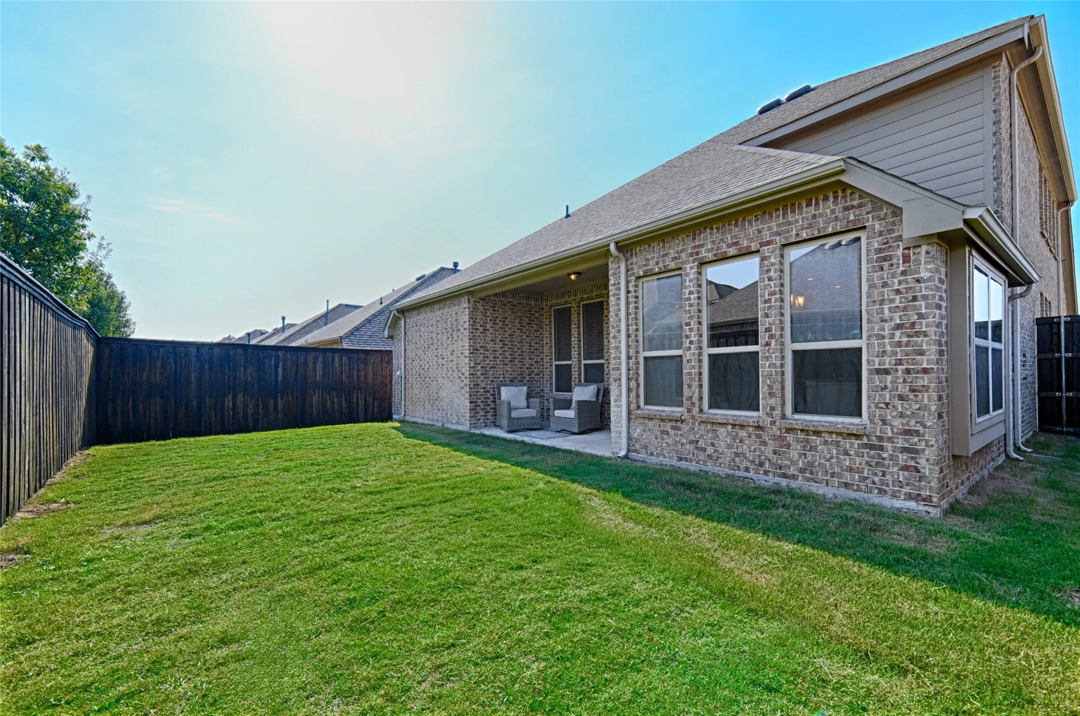 Grass lawn with a wood privacy fence