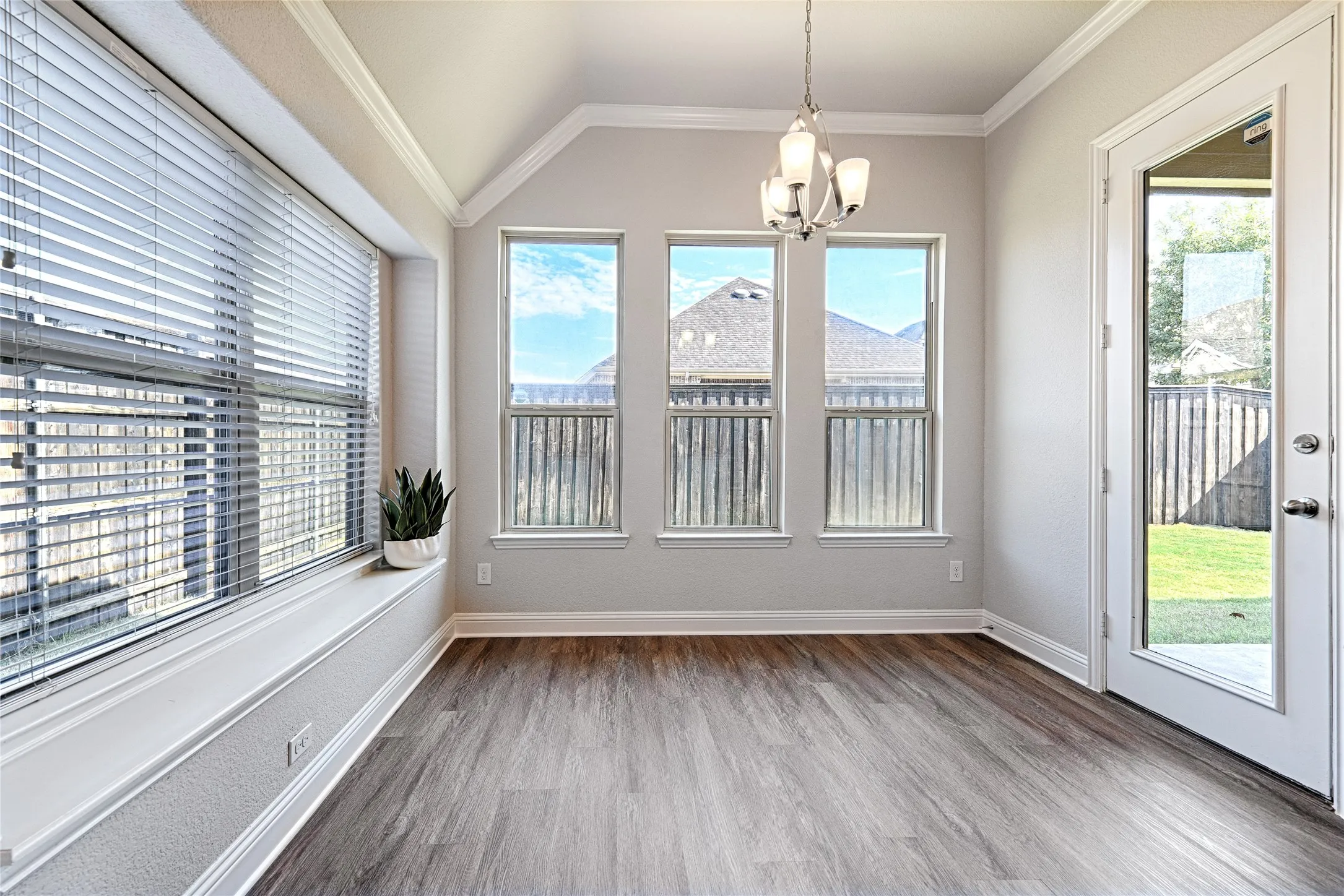 Kitchen Dining with multi-directional natural light and door leading to back porch