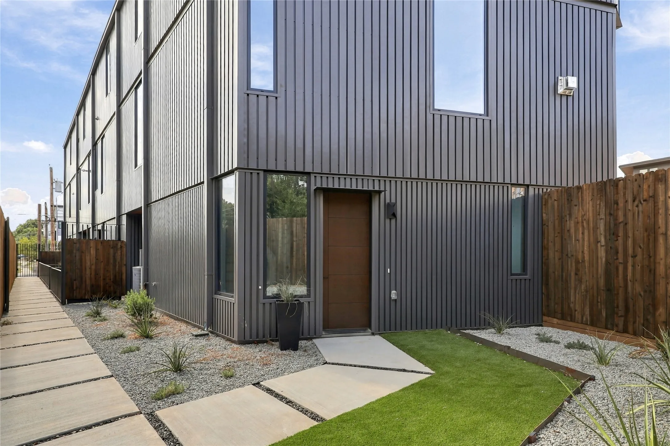 Modern multi-story exterior with vertical panel siding