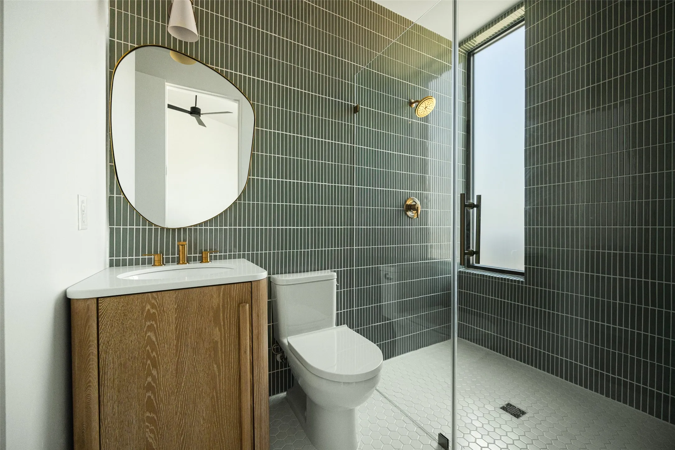 Corner vanity with a white countertop and gold-finish faucet