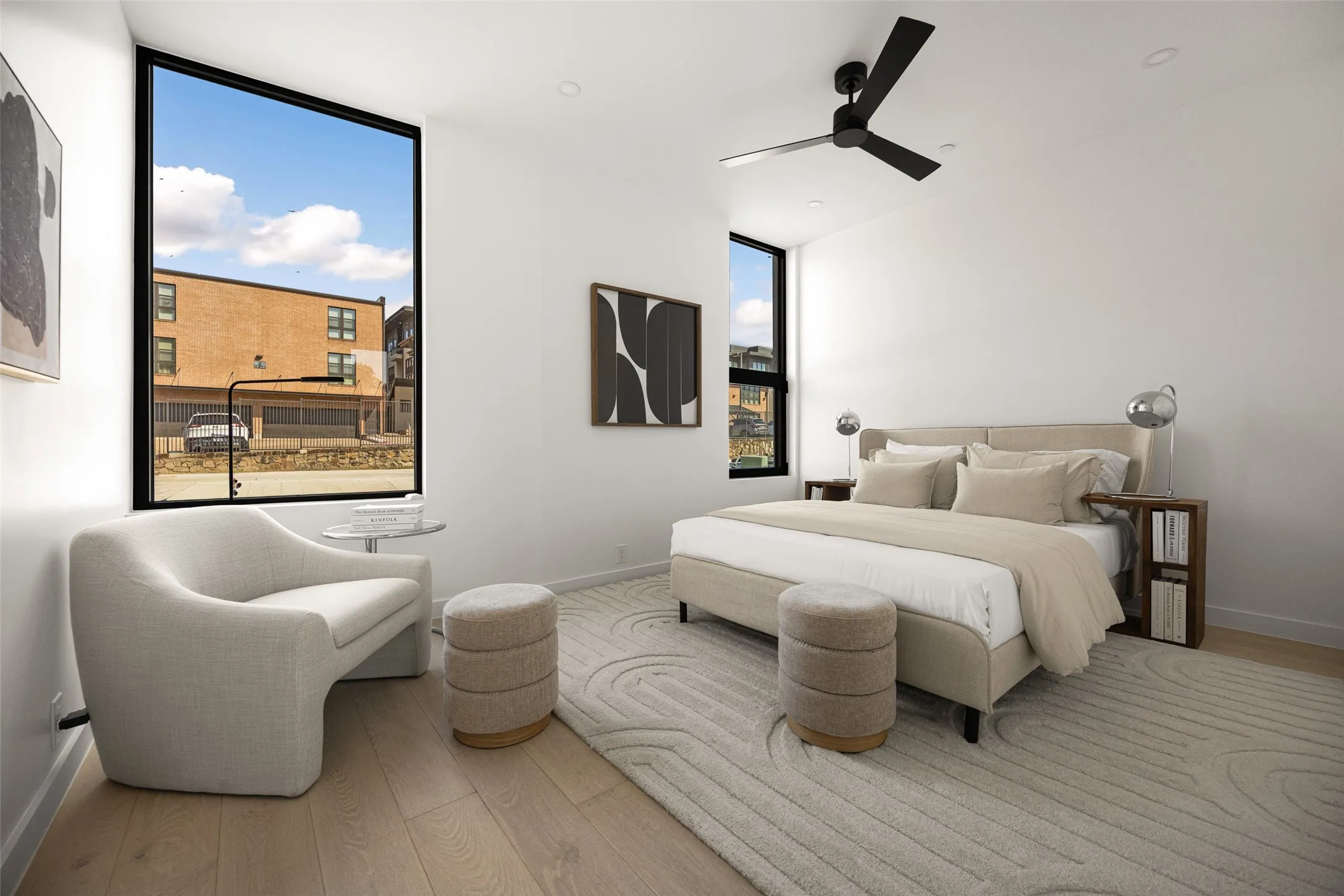 Expansive window, recessed lighting, ceiling fan, wide plank wood-finish flooring, and white walls