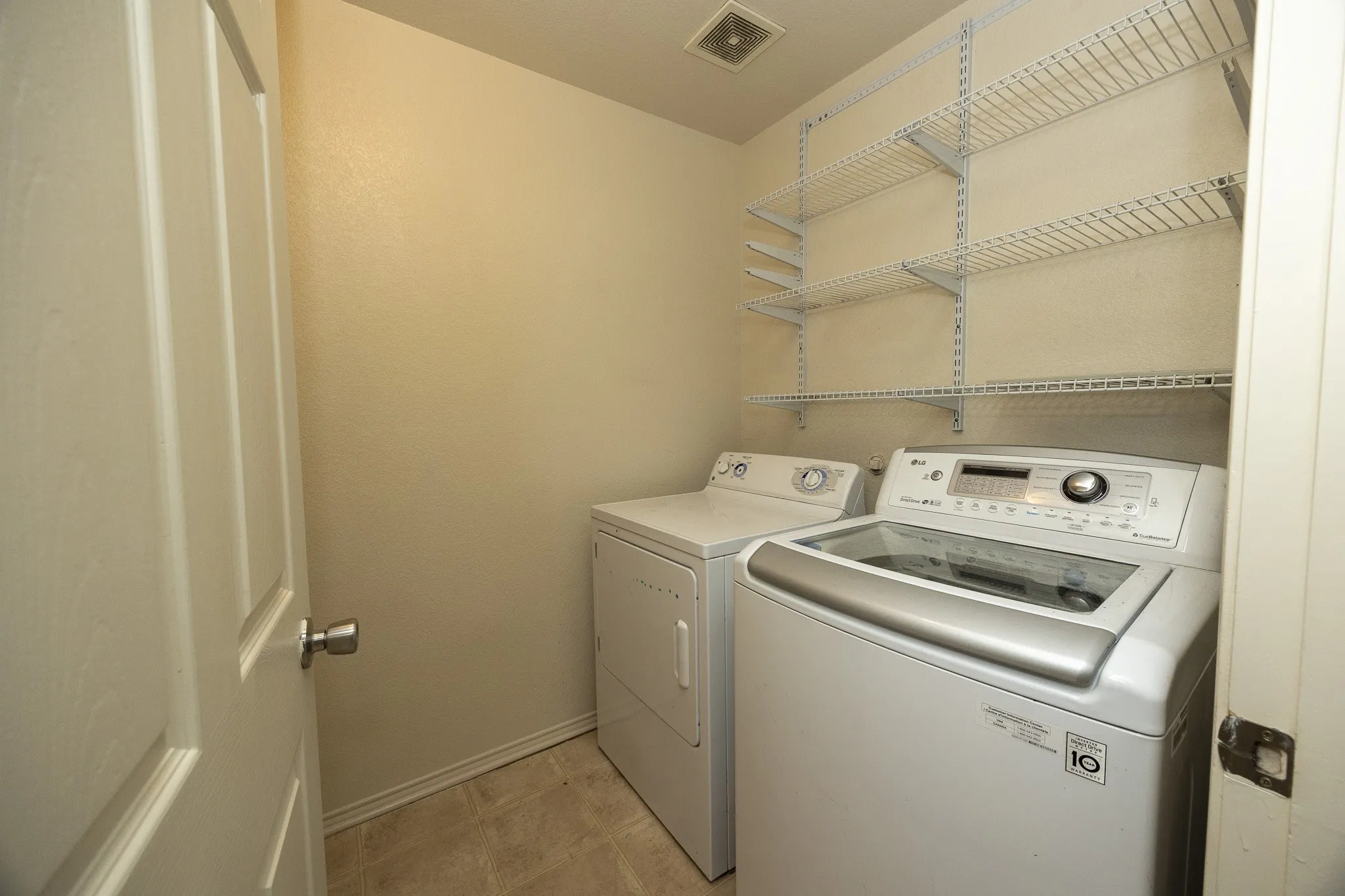 Built-in wire shelving provides ample storage in this utility space