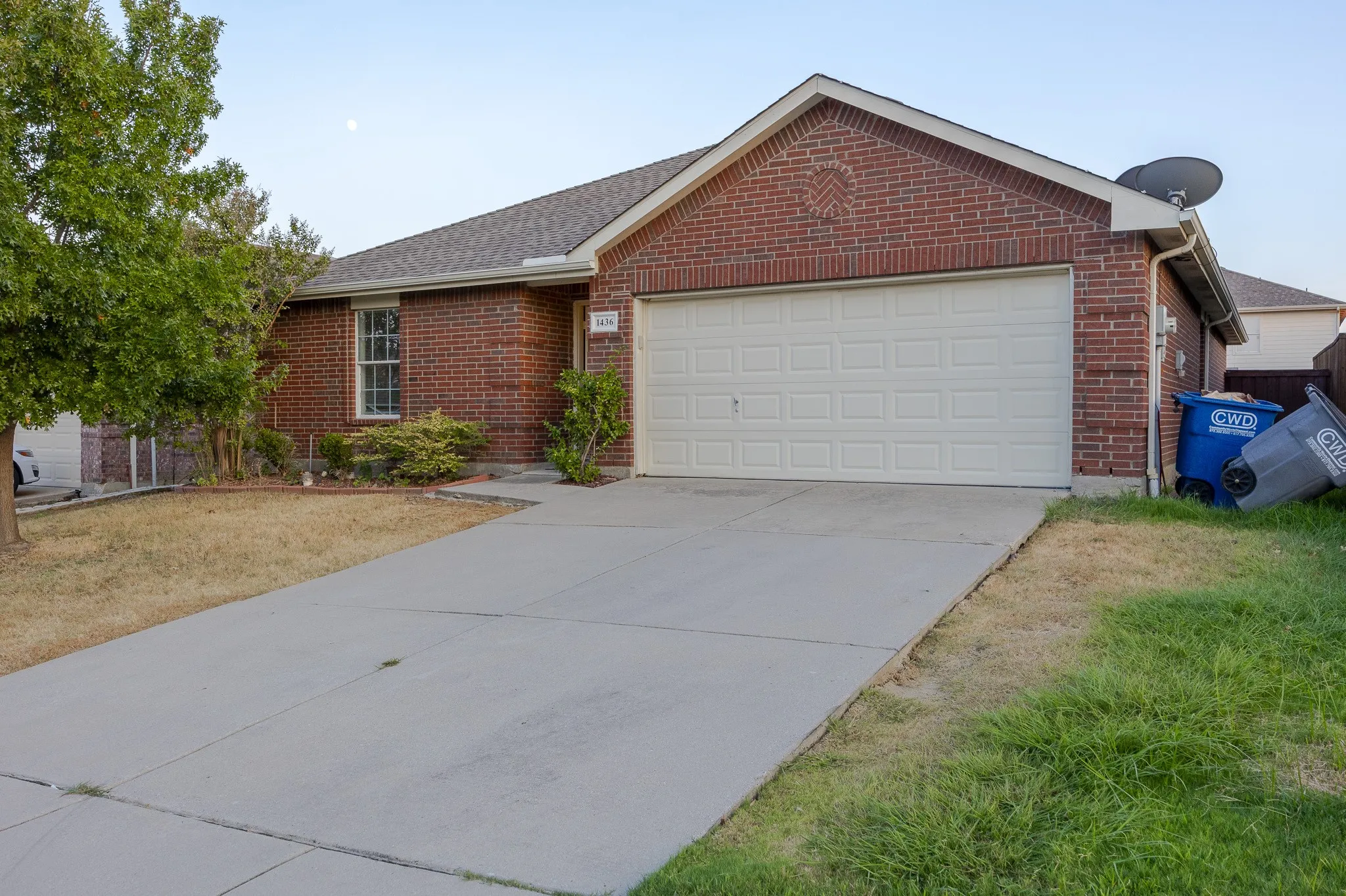 Brick exterior with a gabled roof and attached garage