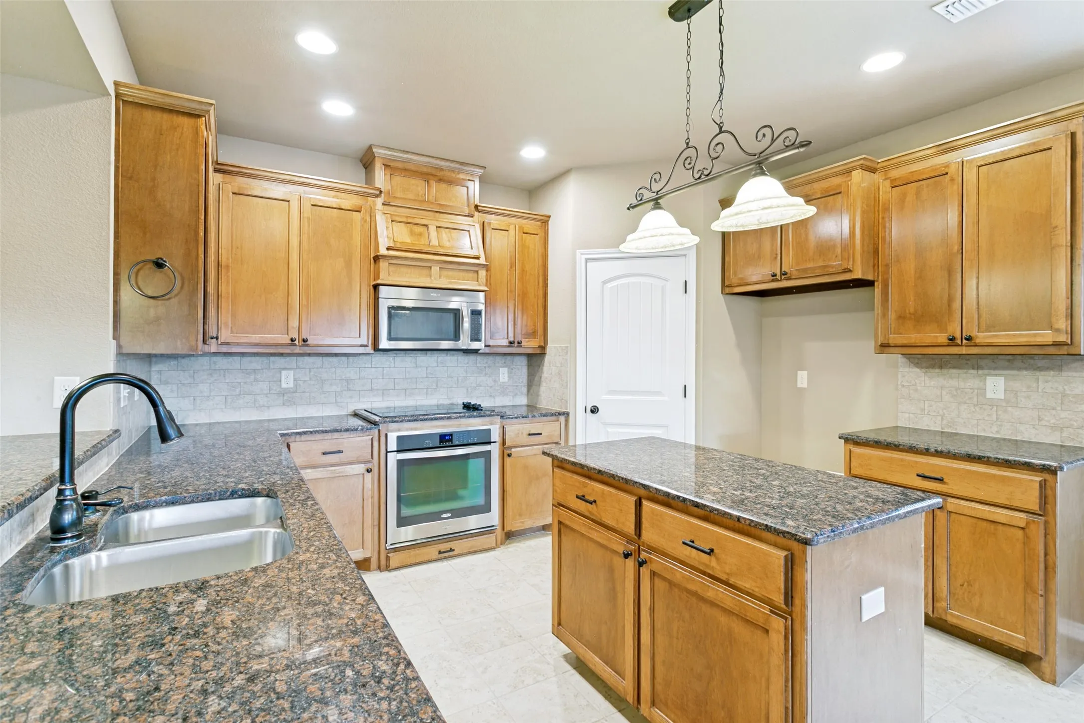 View of the kitchen with lots of storage and pantry.