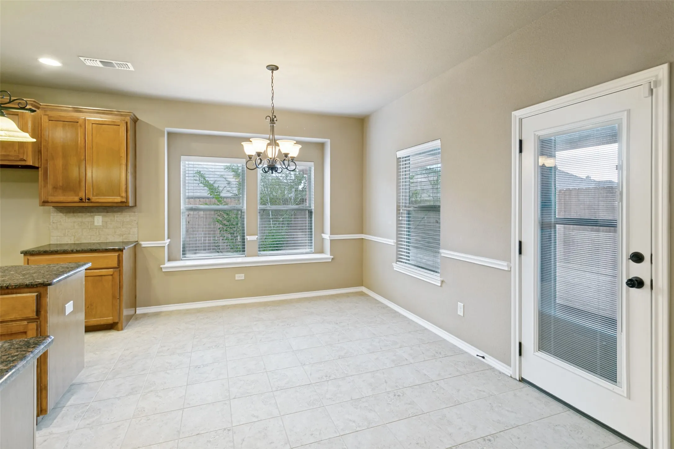Another view of the kitchen and dining room.