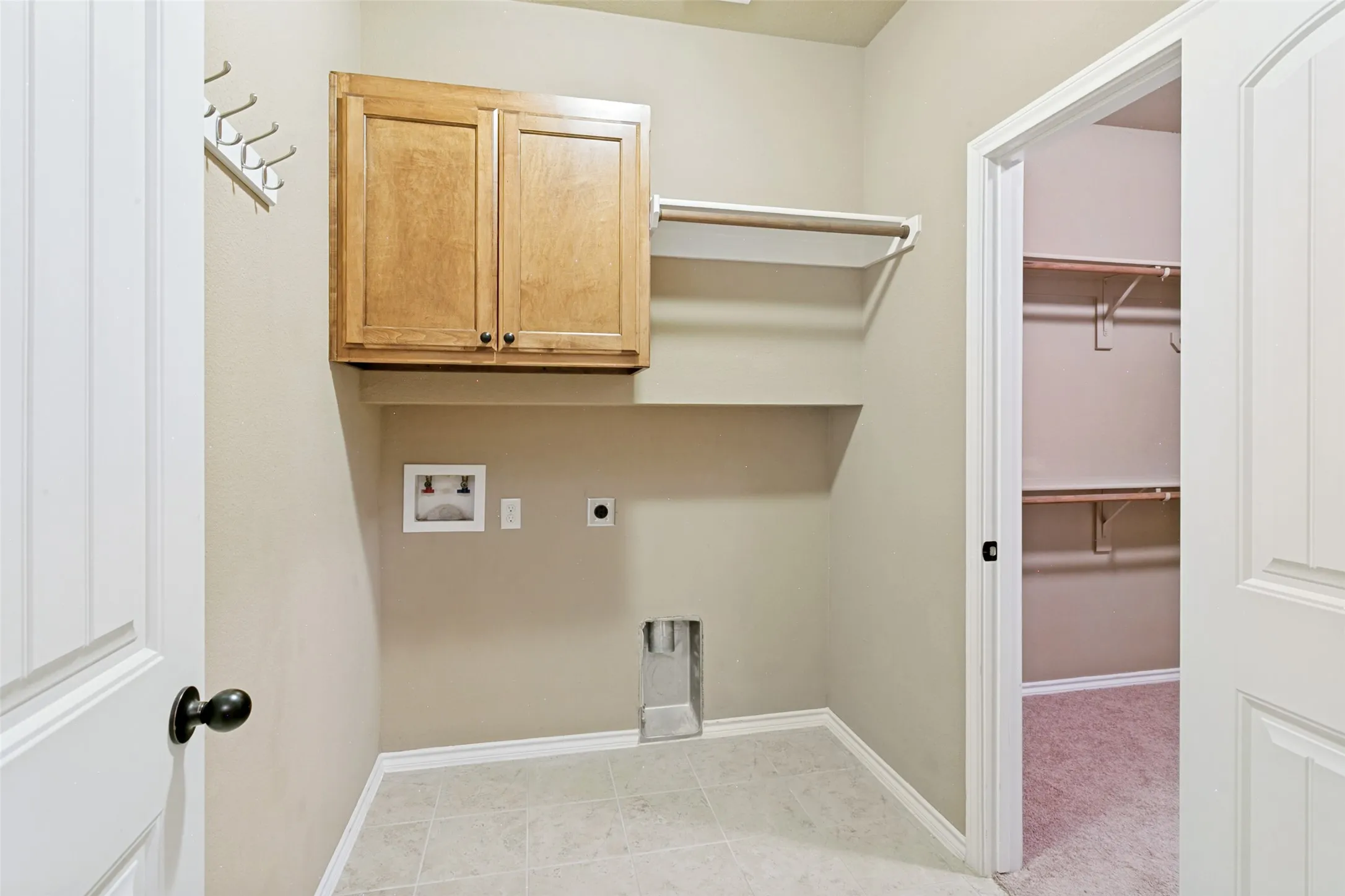 Laundry room is on the other side of the walk in closet from the primary bedroom and there is also another entry to the laundry room.