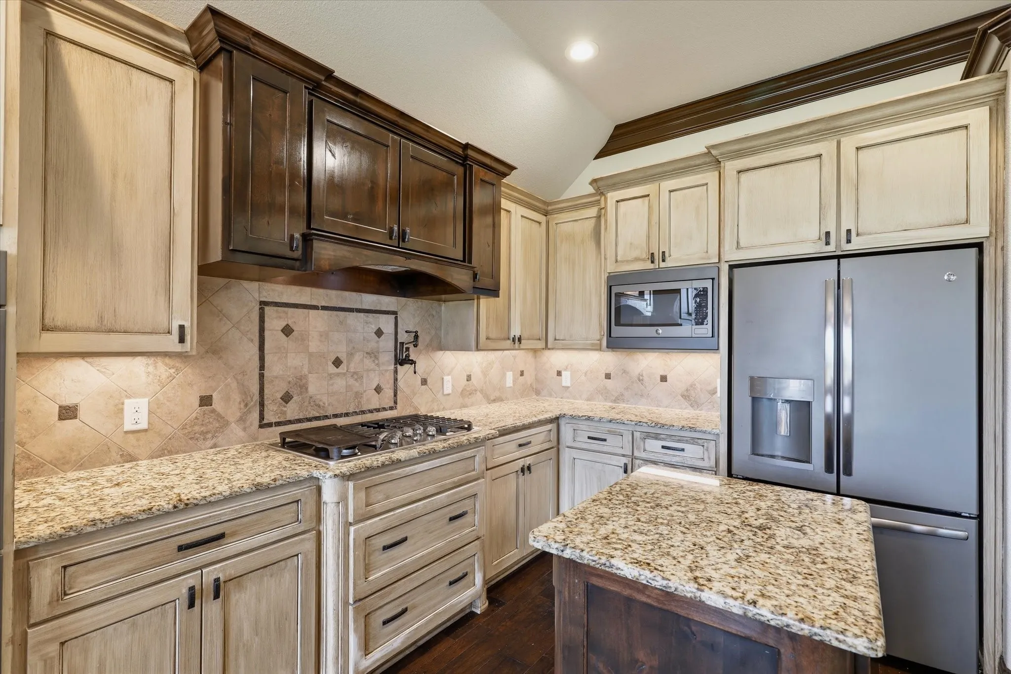 Granite countertops and an extensive tile backsplash.